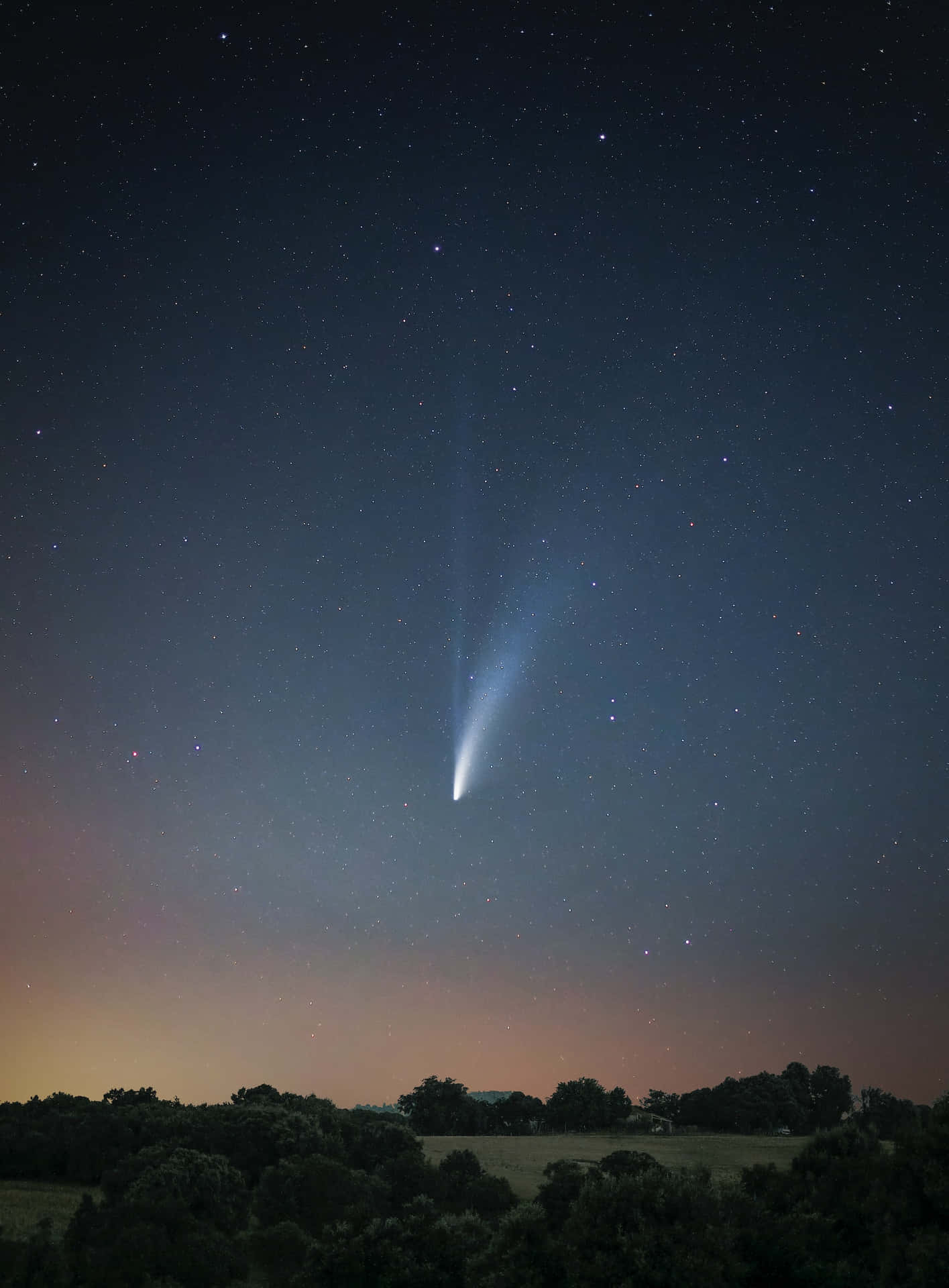 A Sweeping Comet Across The Night Sky Wallpaper