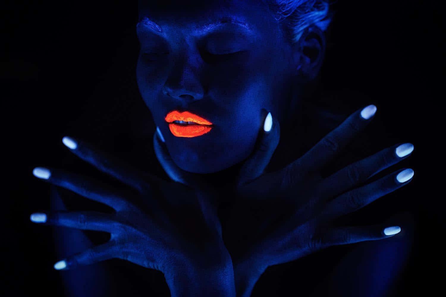 A Vibrant Display Of Neon Makeup Under Black Light Wallpaper