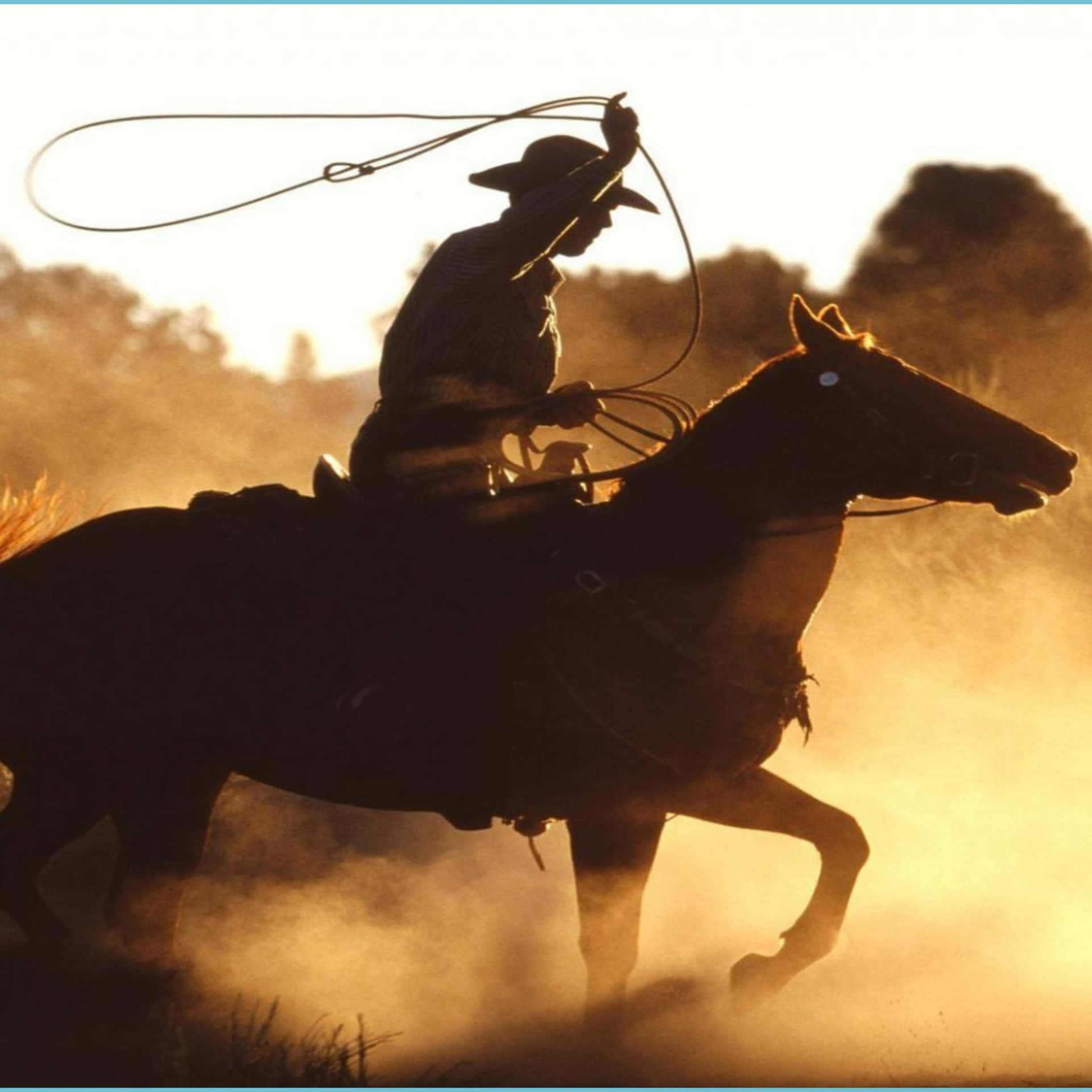 A Western Cowboy With His Trusty Horse Against A Sunset Backdrop Wallpaper