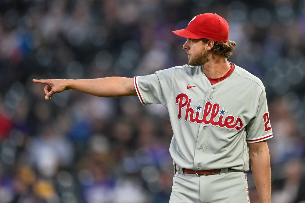 Download Aaron Nola, a star player, pointing to victory Wallpaper