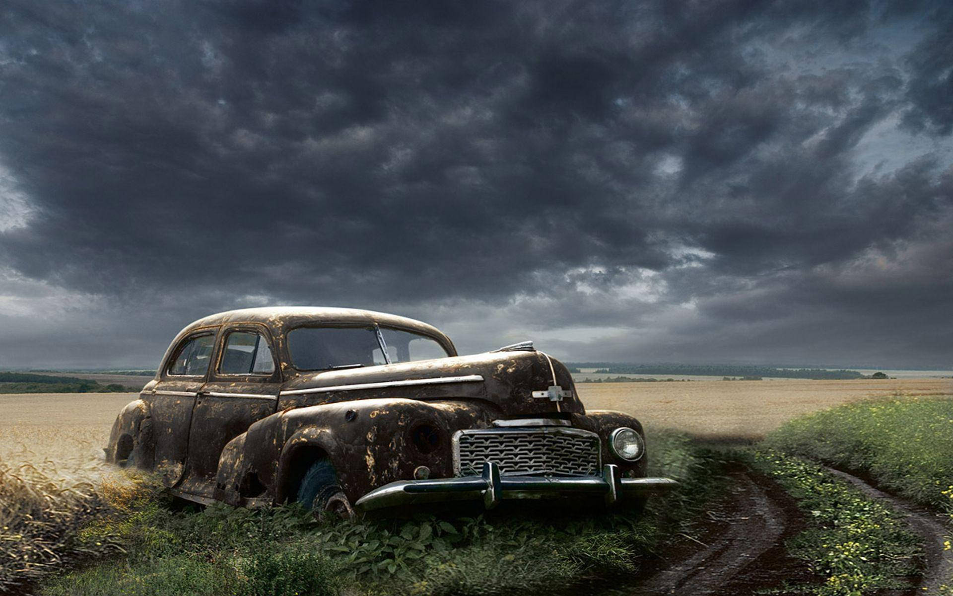 Nostalgic Remnant: Abandoned Old Car in Field Wallpaper