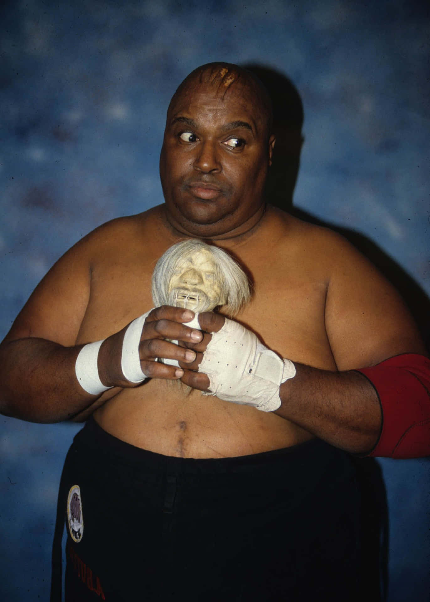 Abdullah The Butcher Holding Old Doll Wallpaper
