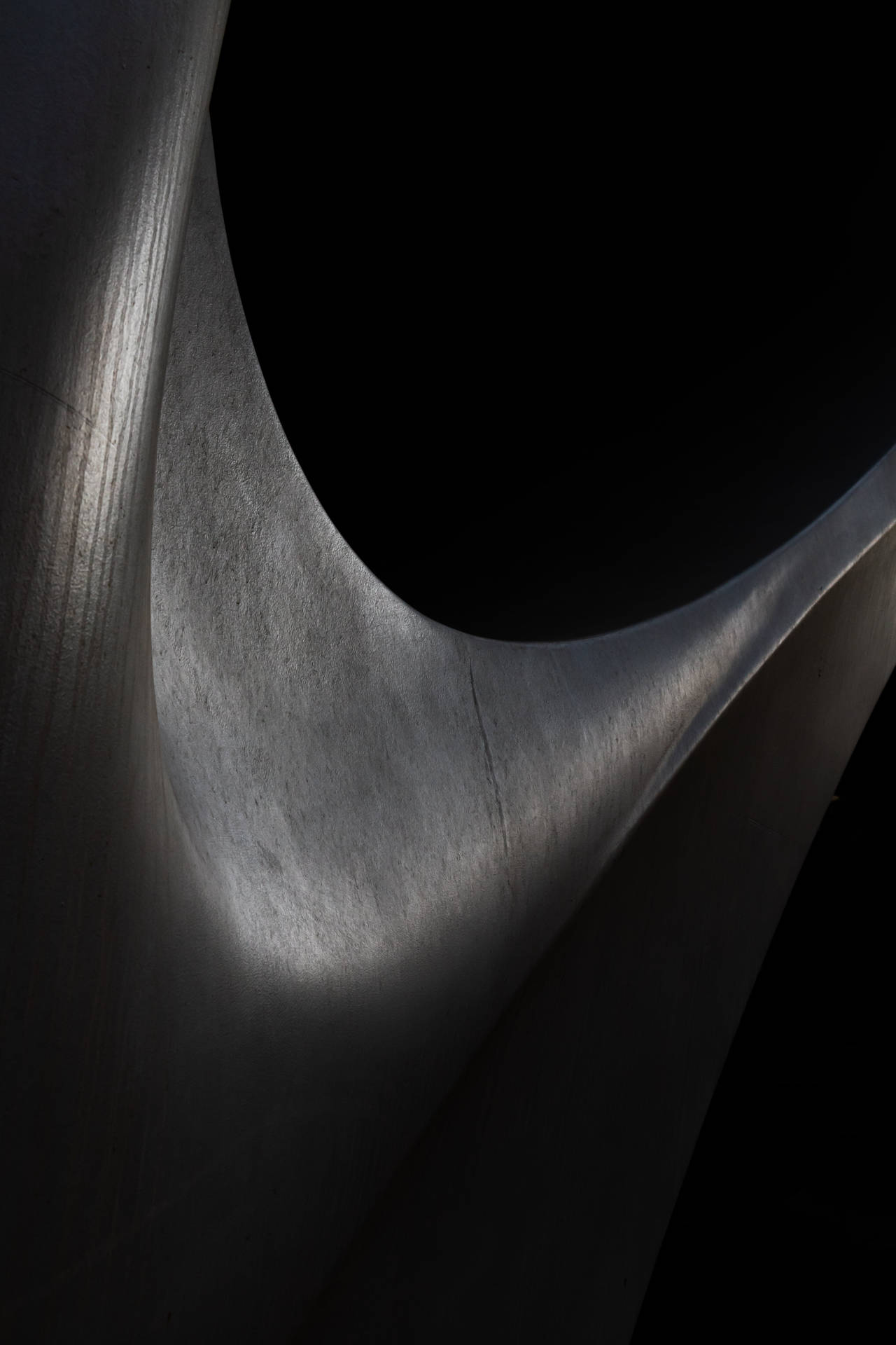 Abstract Black Sculpture in a Dimly Lit Room Wallpaper