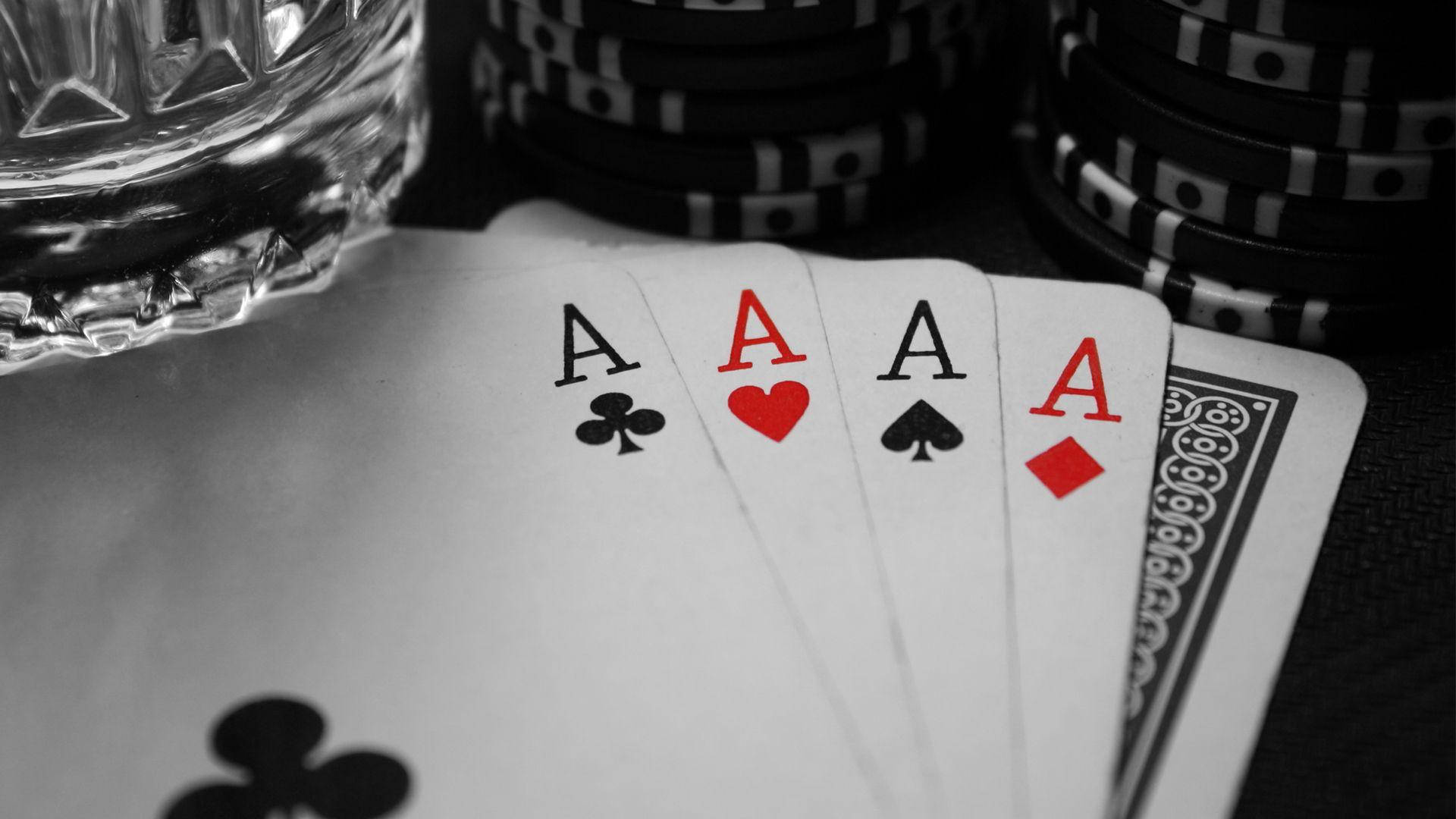 A Poker Table With A Glass Of Water And Cards Wallpaper
