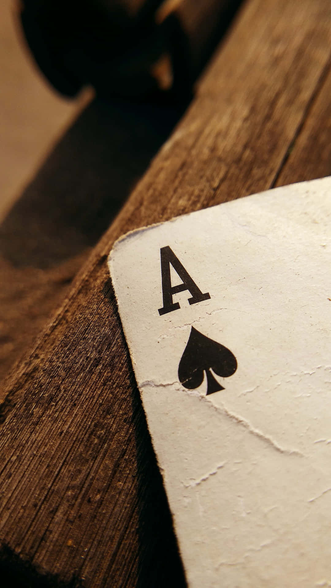 Aceof Spades Card Edgeon Wooden Table Wallpaper