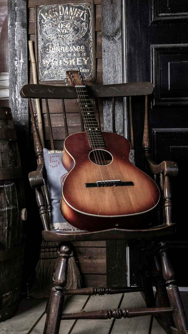 Acoustic Guitar On Rocking Chair Wallpaper