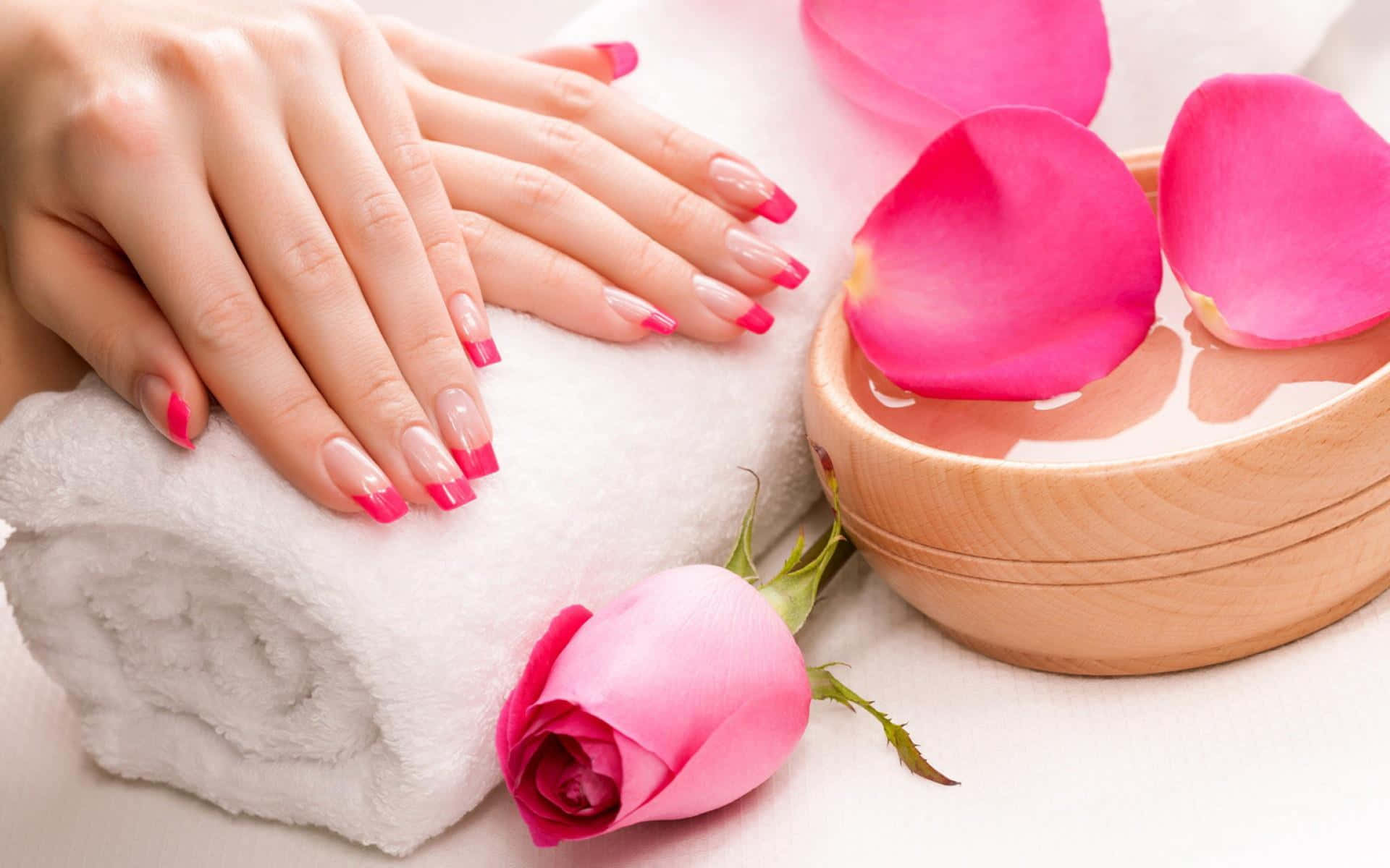 A Woman's Hands With Pink Nails And Roses On A Towel Wallpaper