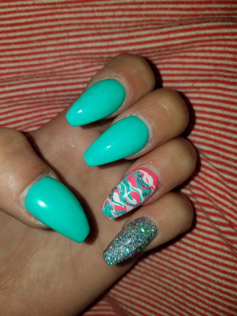 A Person Holding Up A Green And Silver Nail With A Glitter Design Wallpaper