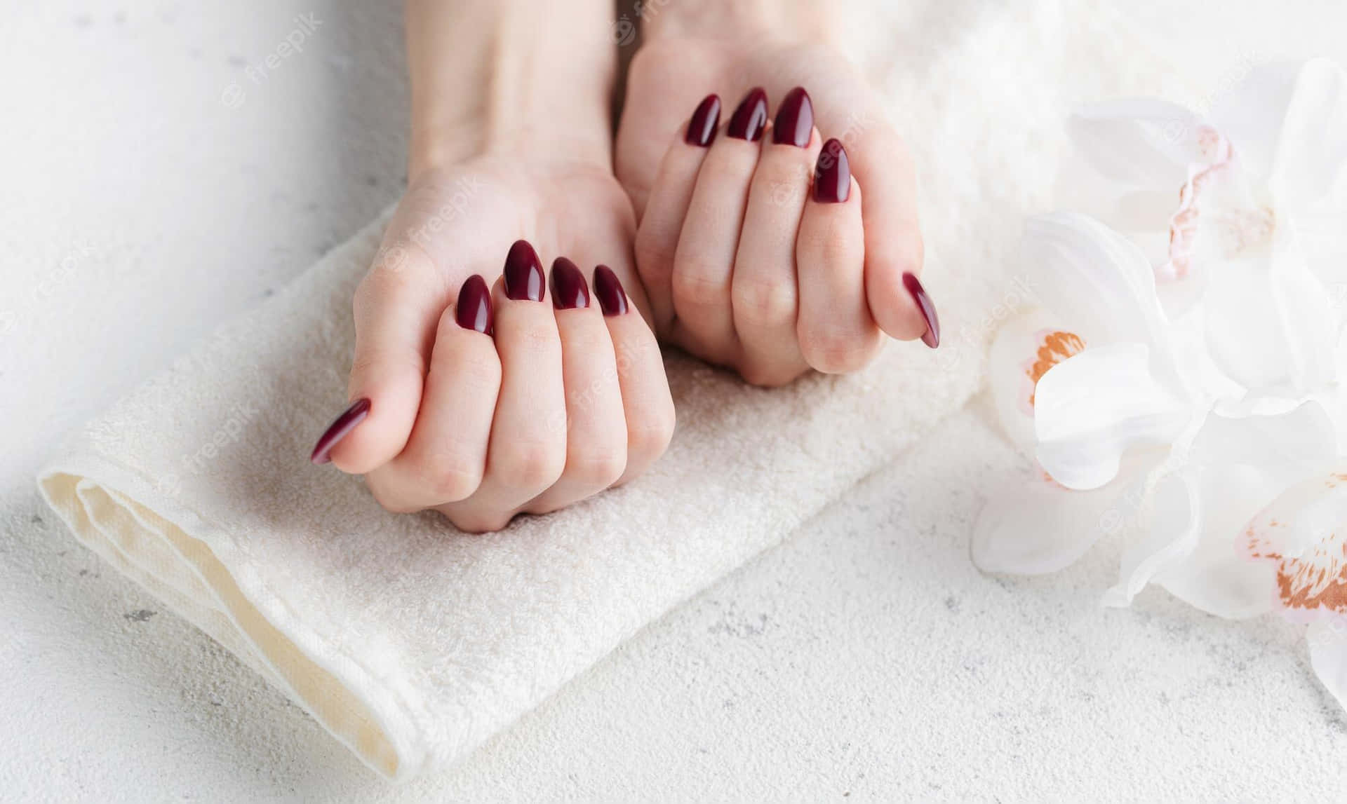 A Woman With Burgundy Nails Holding A Towel Wallpaper