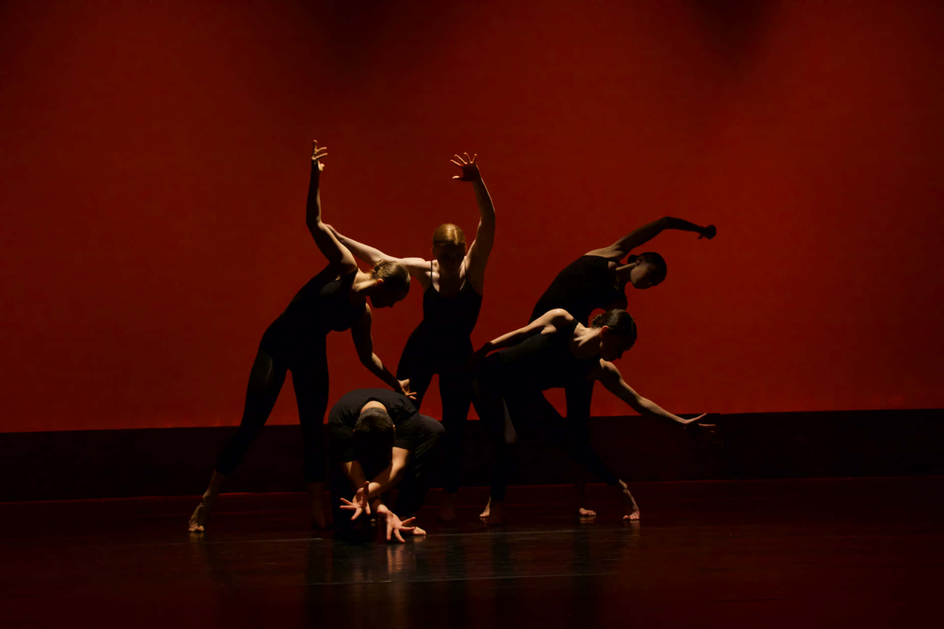 A Group Of Dancers In Black And Red Wallpaper