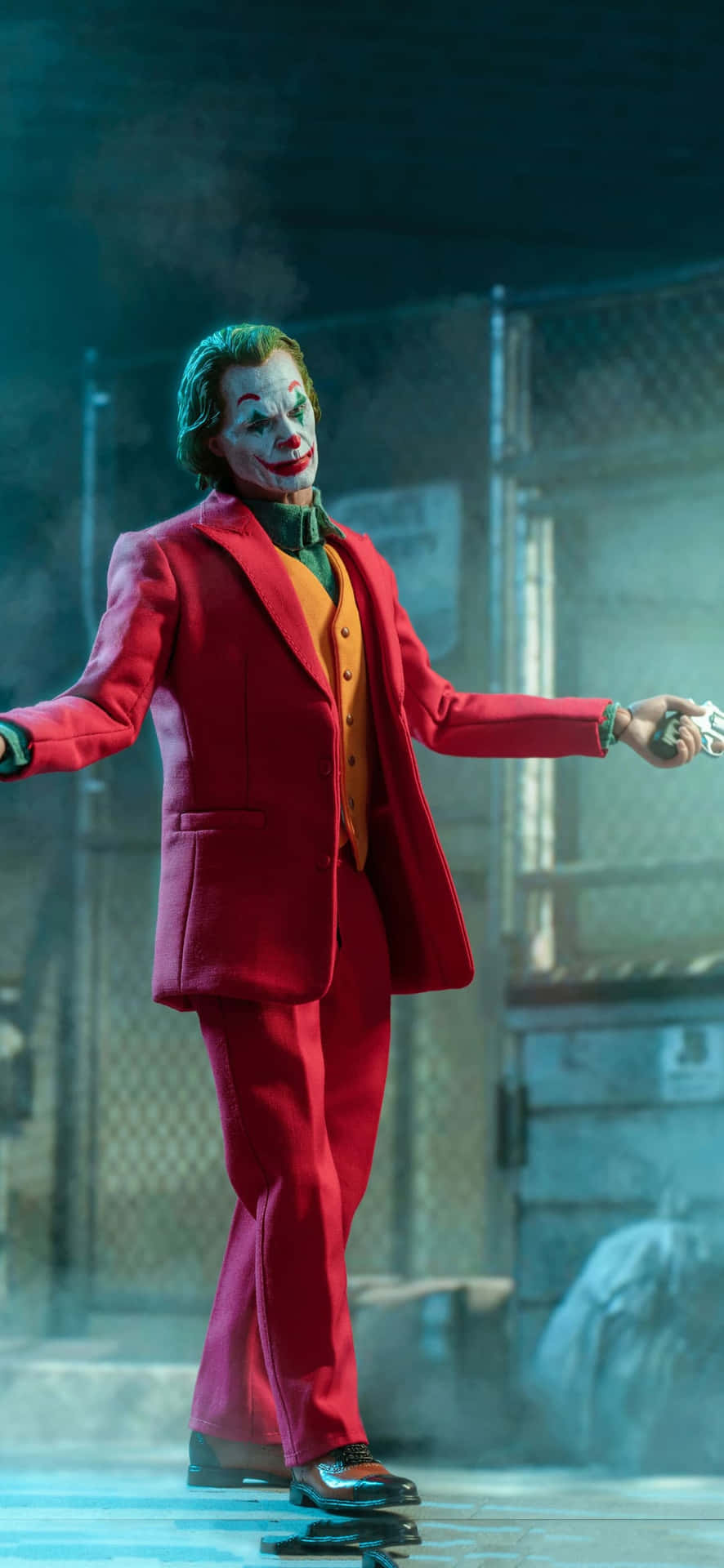 The Joker Is Holding A Gun And Is Holding A Gun Wallpaper