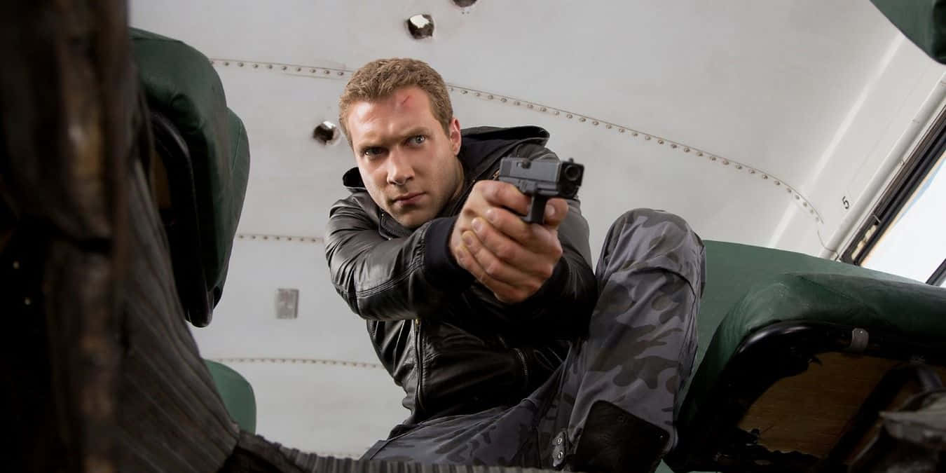 Action Hero Aiming Gun Wallpaper