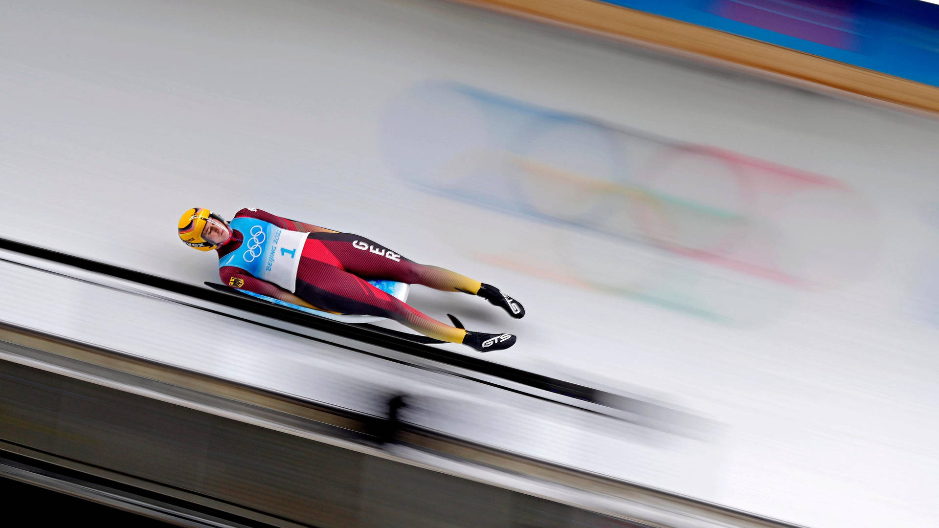 Fearless Luge Athlete in High-Speed Action Wallpaper