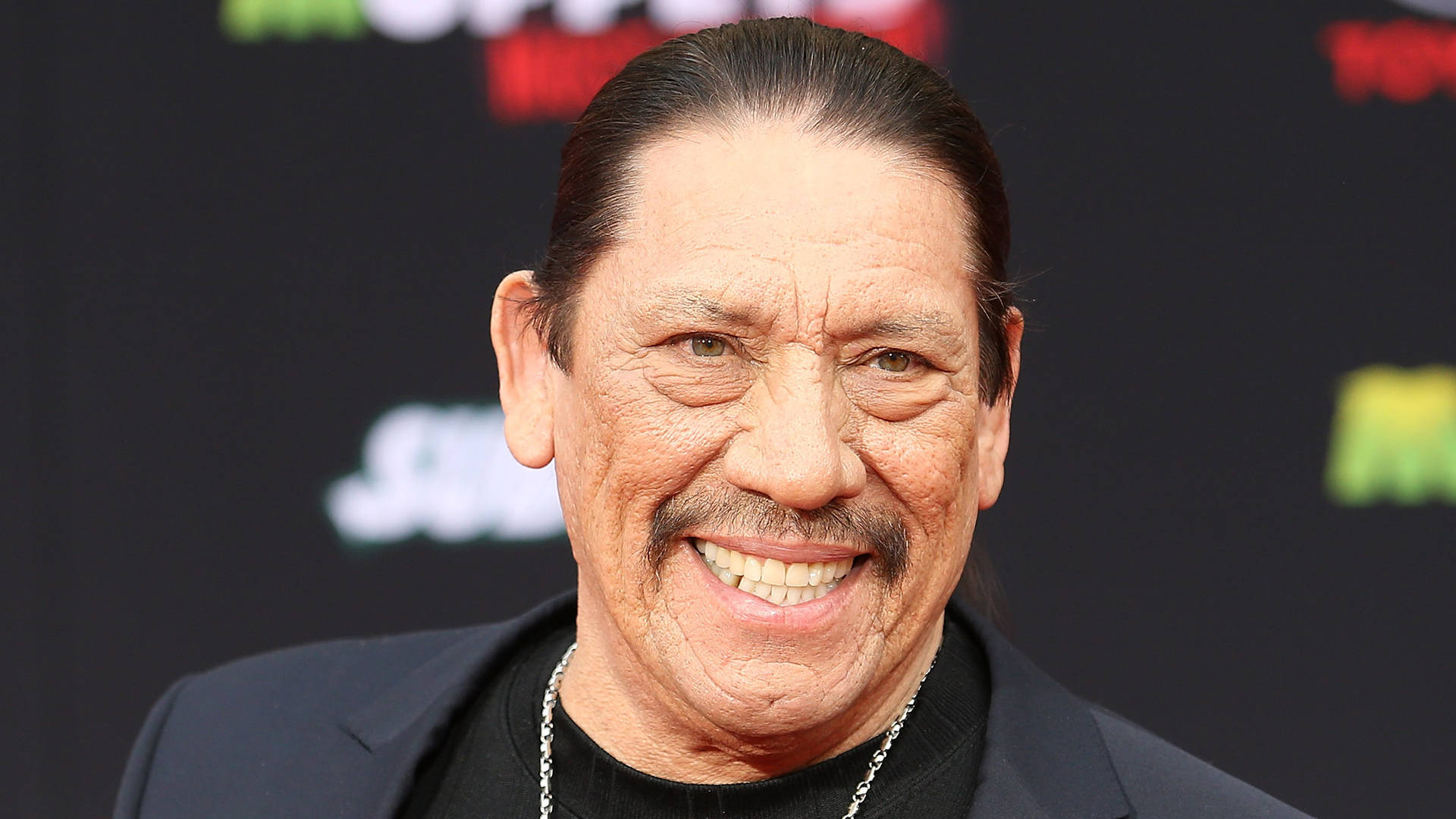 Actor Danny Trejo Smiling In Red Carpet Picture