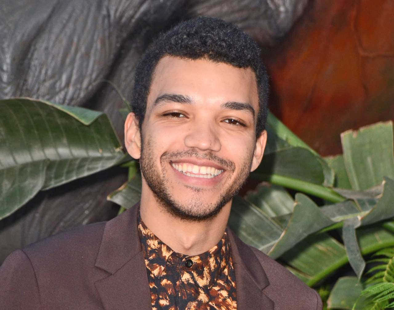 Actor Justice Smith, Stylish And Confident Wallpaper
