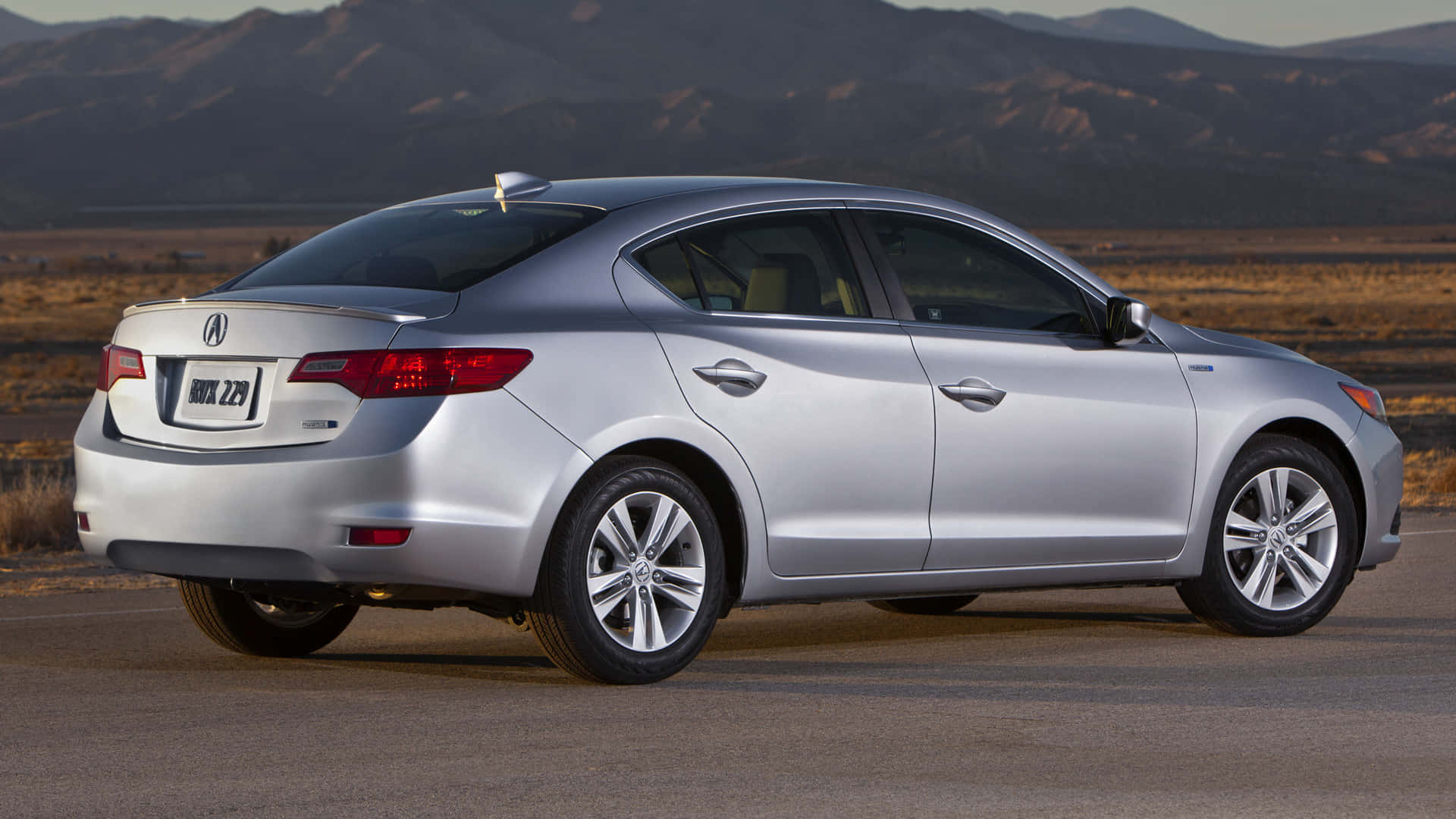 Sleek Acura ILX parked on a scenic mountain road with a picturesque backdrop Wallpaper