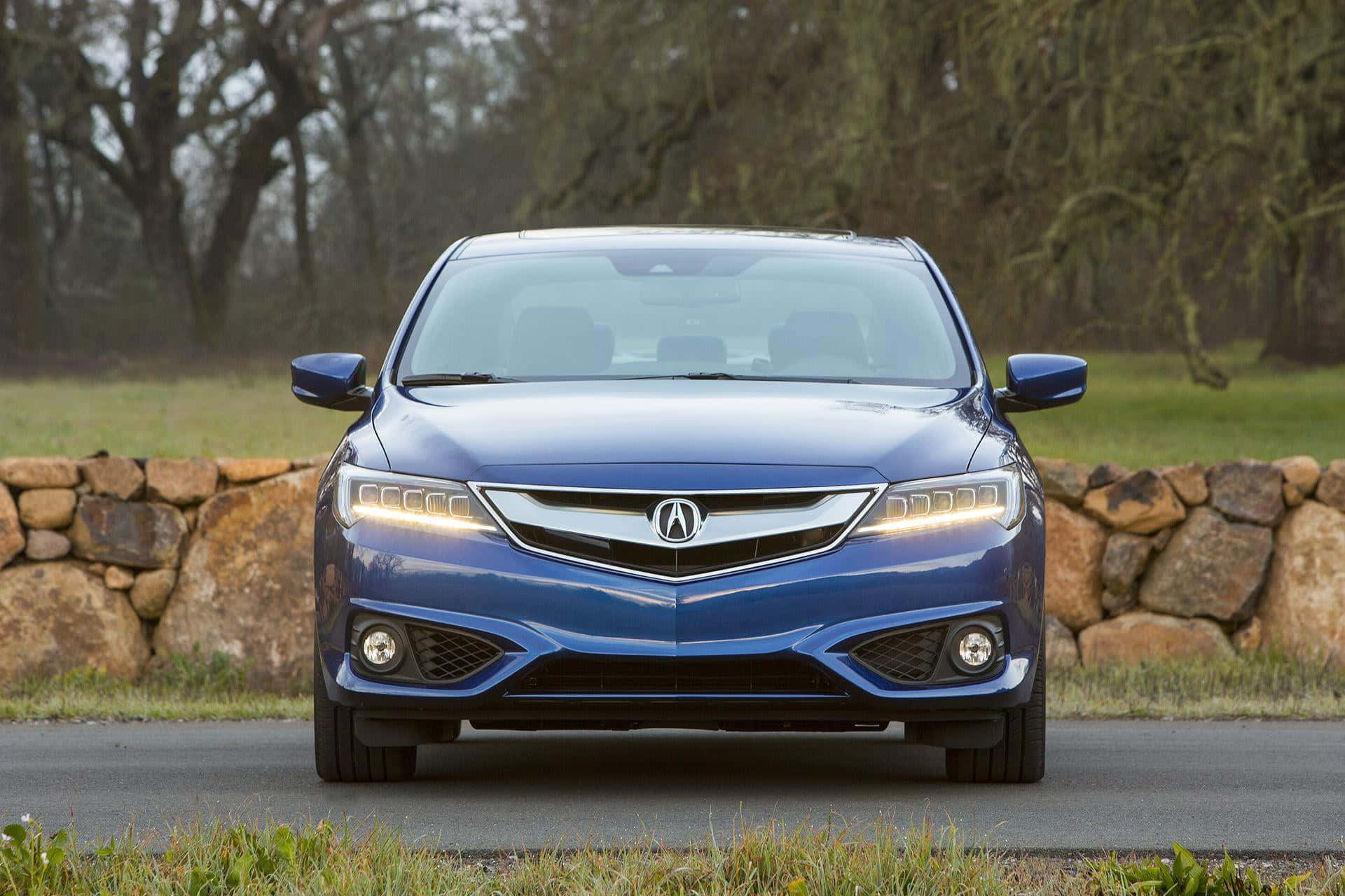Sleek Acura ILX driving on a scenic road Wallpaper
