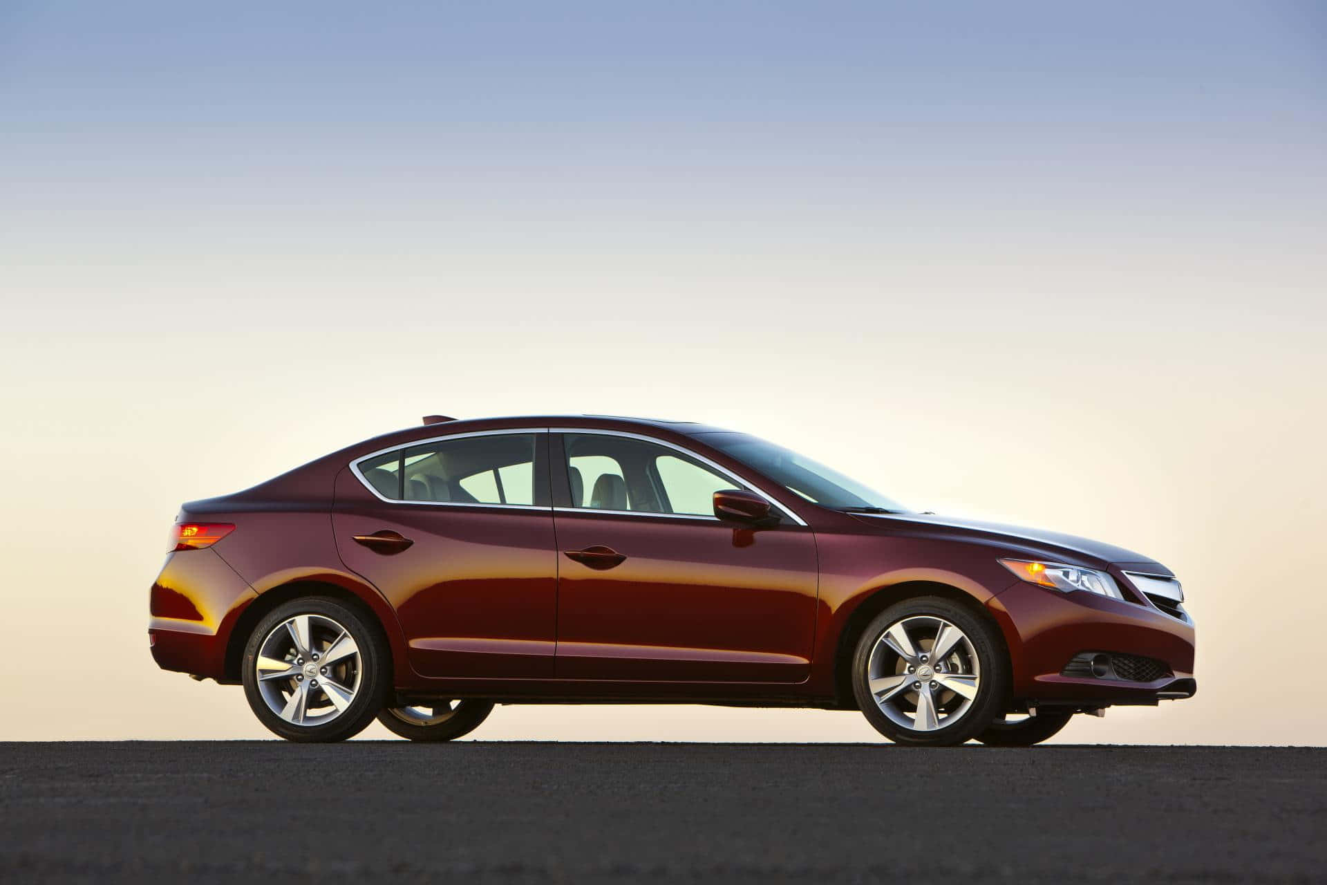A sleek Acura ILX on the road showcasing its elegant design and stunning performance Wallpaper
