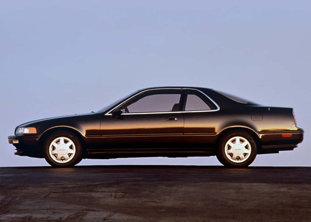 Caption: Sleek Acura Legend Cruising the Night Wallpaper