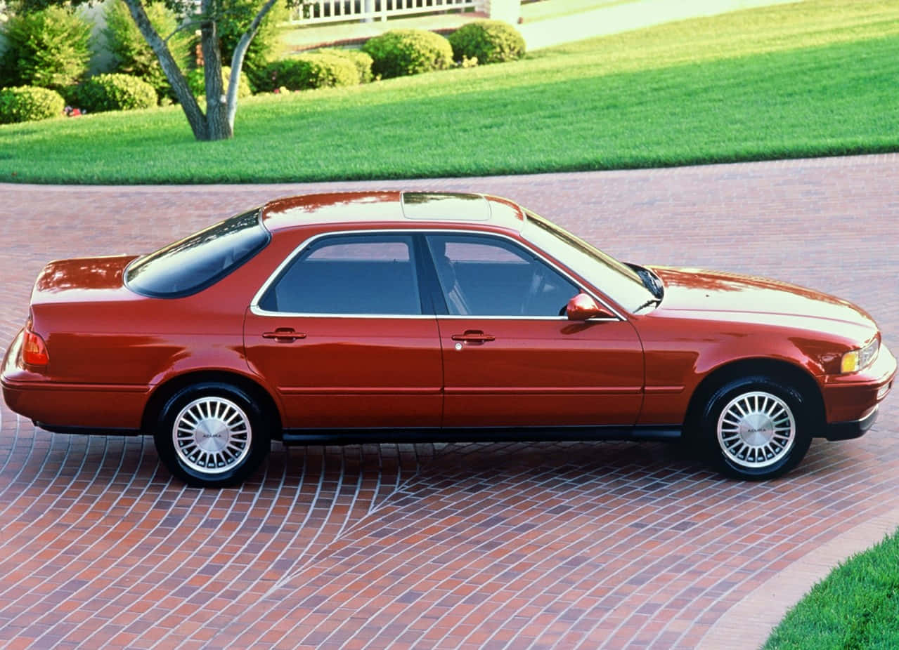 Classic Acura Legend Cruising on an Open Road Wallpaper