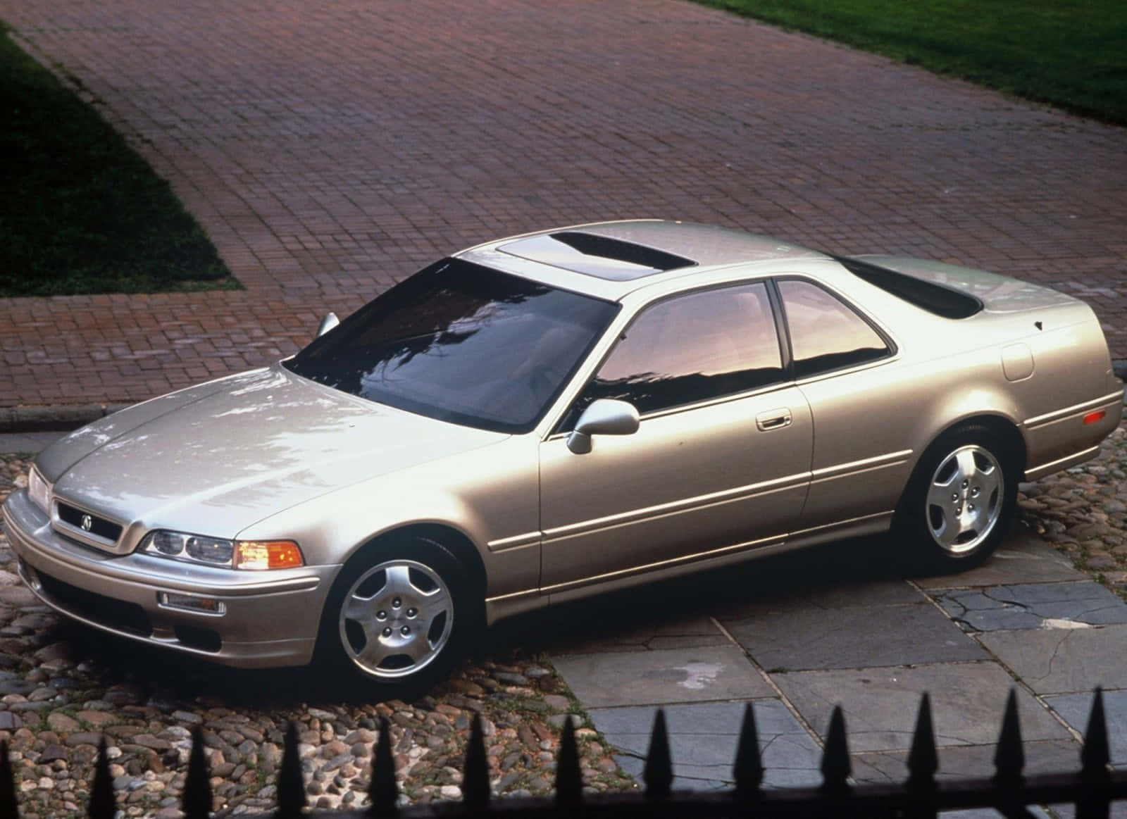 A sleek Acura Legend parked on the streets during a beautiful sunset. Wallpaper