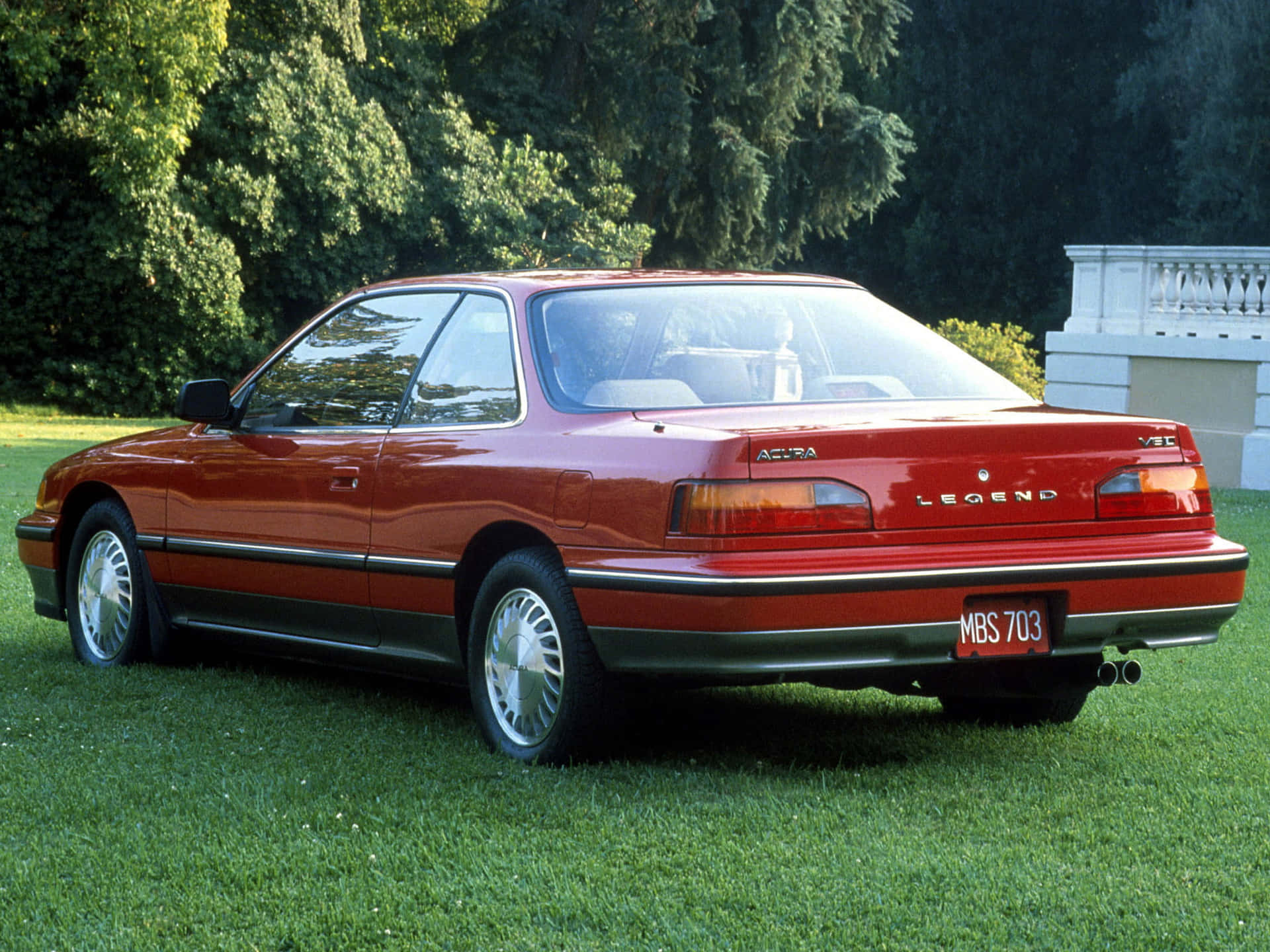 Acura Legend Cruising on a Highway Wallpaper