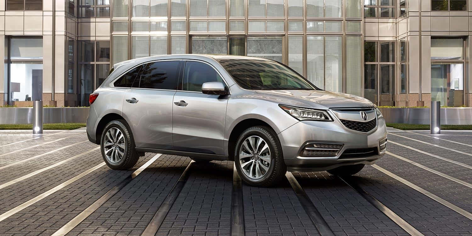 Stunning Acura MDX on the road reflecting the beauty of modern design and performance Wallpaper