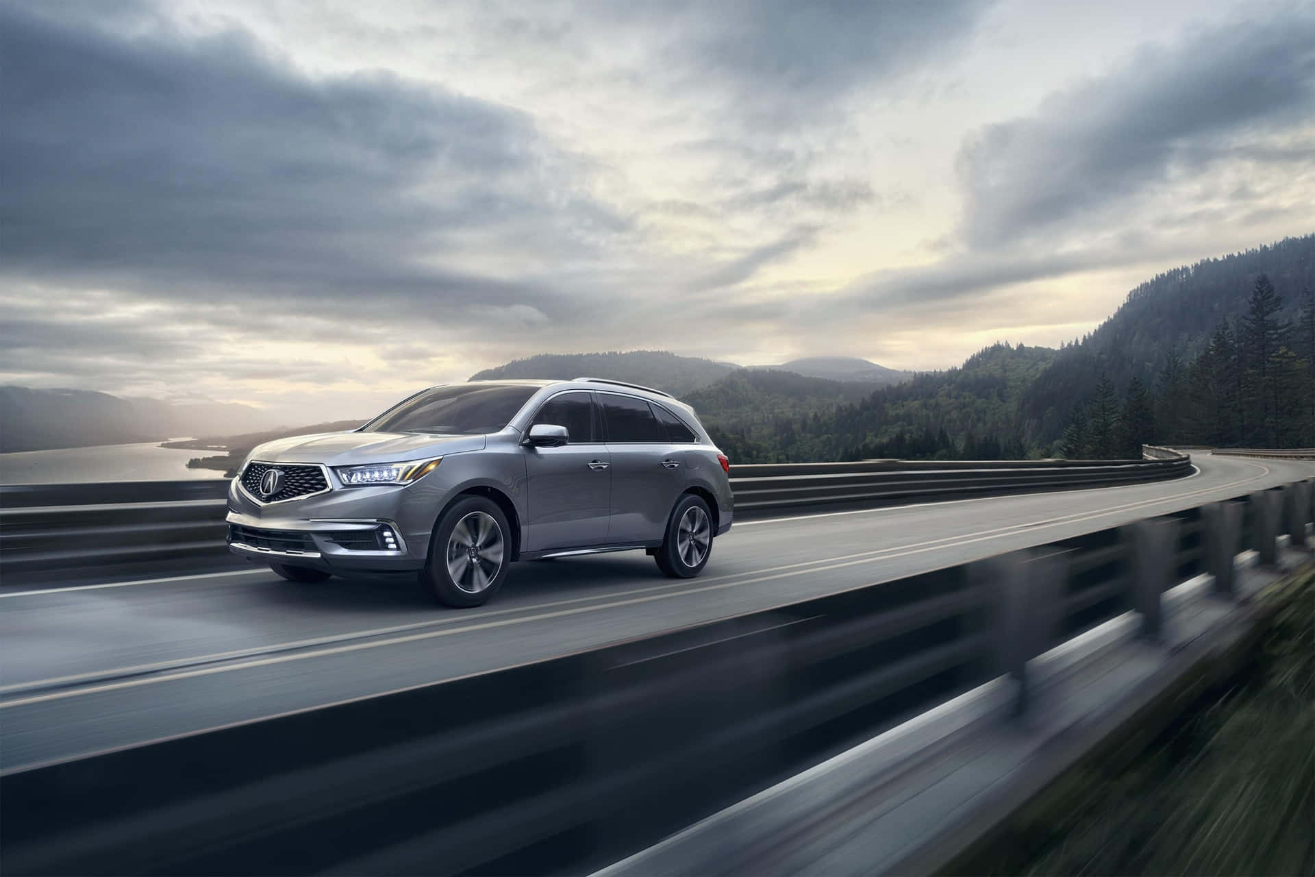 Stunning Acura MDX in motion on a scenic road Wallpaper