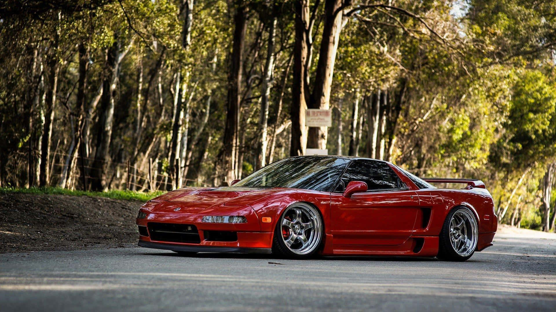 Sleek Red Acura NSX on a Scenic Highway Wallpaper