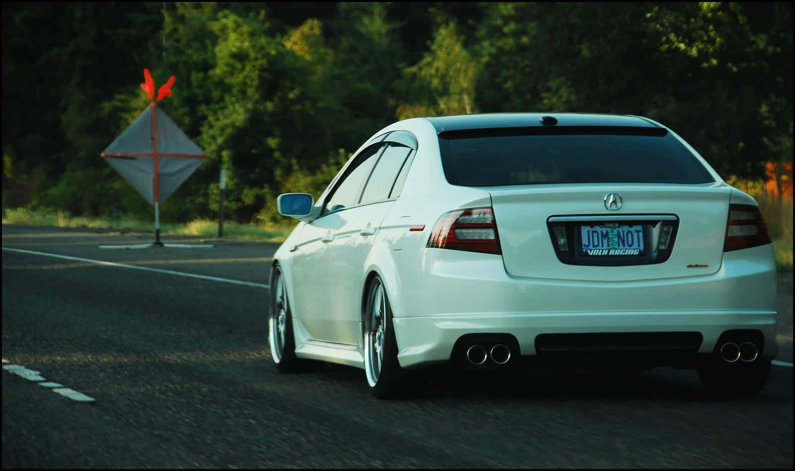 Sleek Acura TL cruising down the highway. Wallpaper