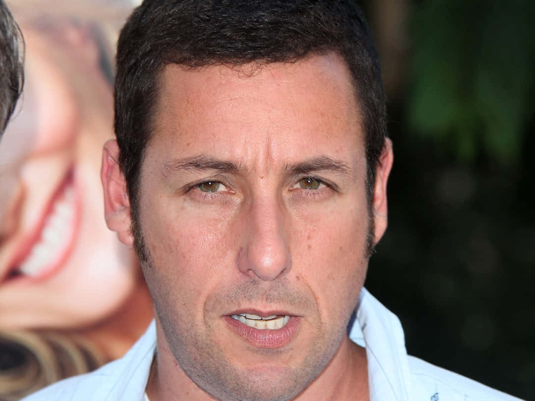 Actor Adam Sandler is all smiles as he poses for a publicity photo