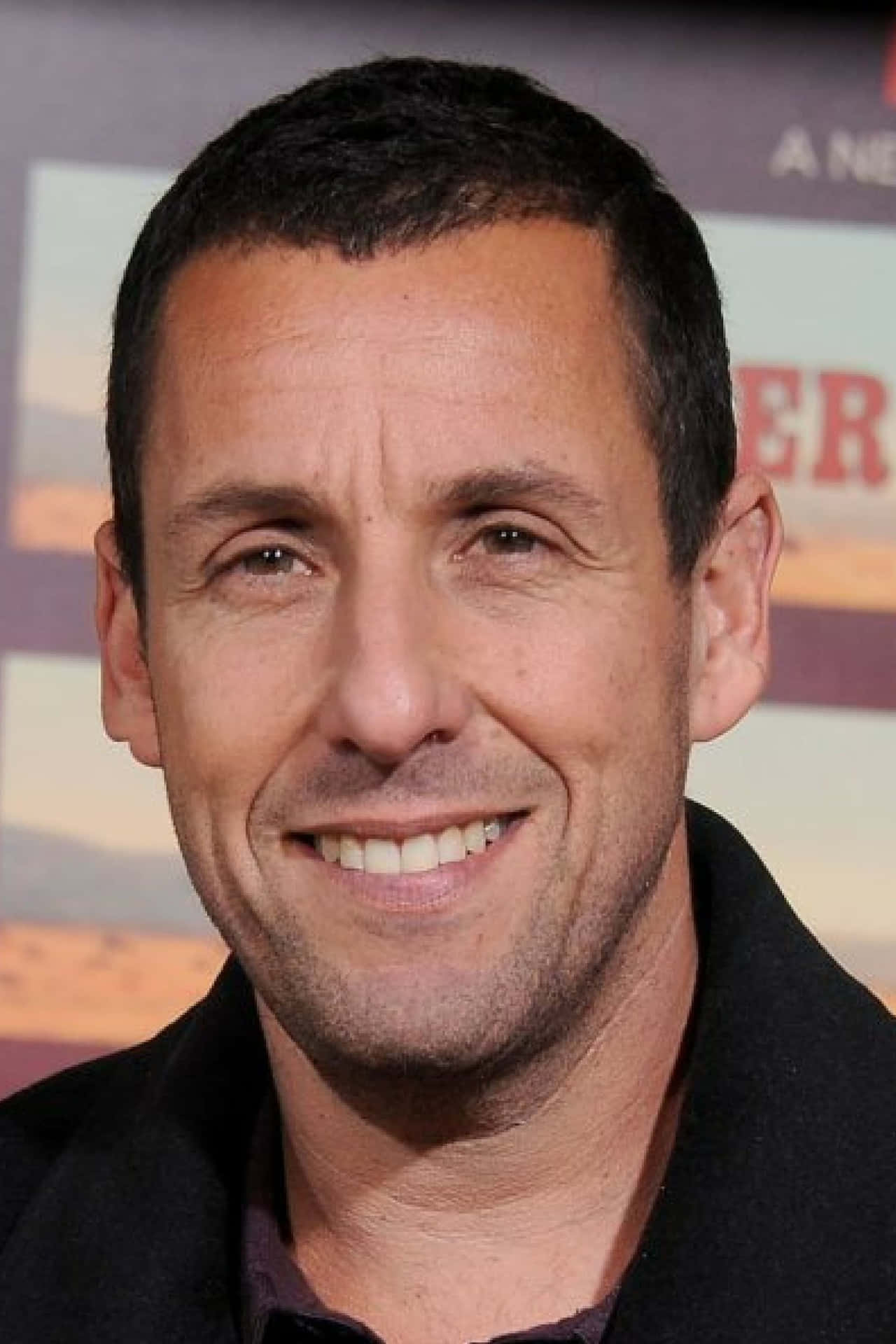 Text  Adam Sandler has a laugh on the set of one of his films