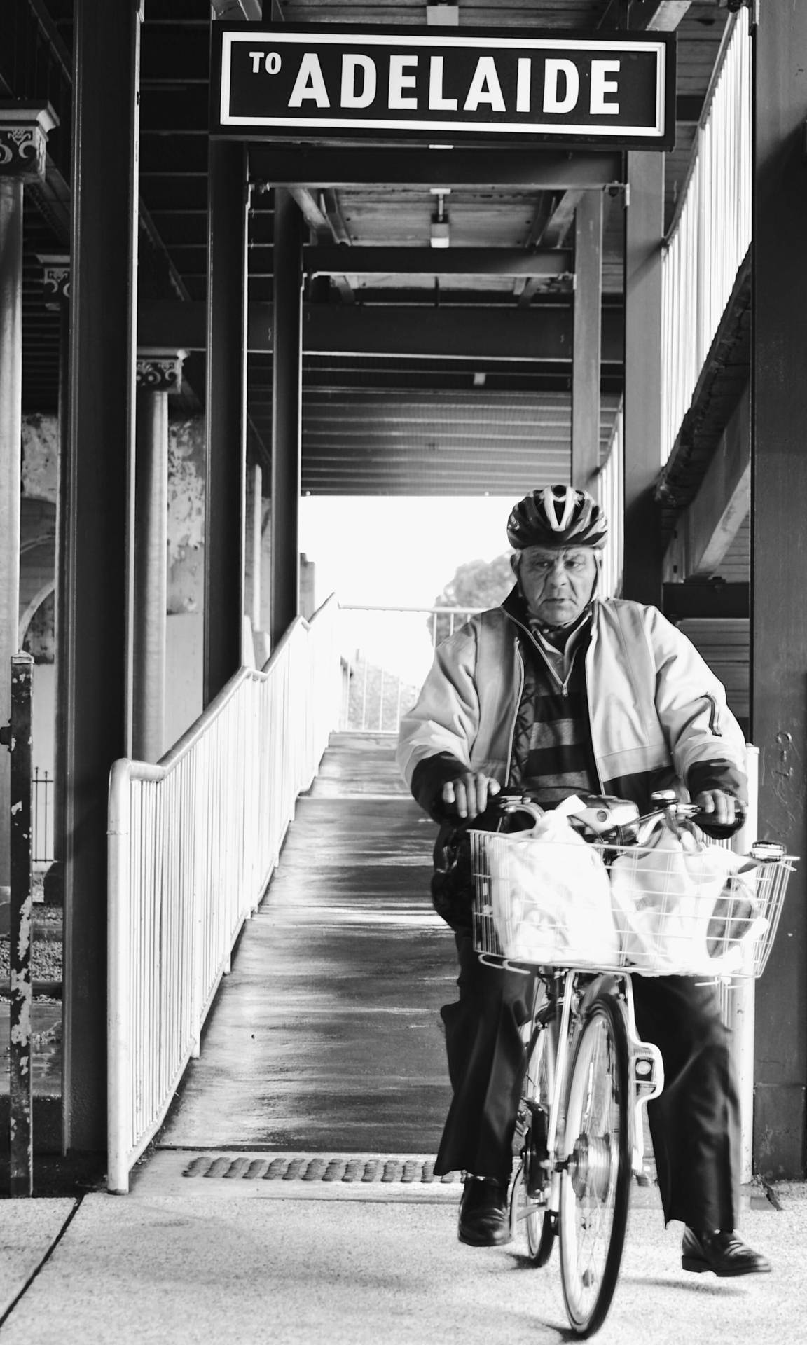 Adelaide Signage Above Elderly On Bicycle