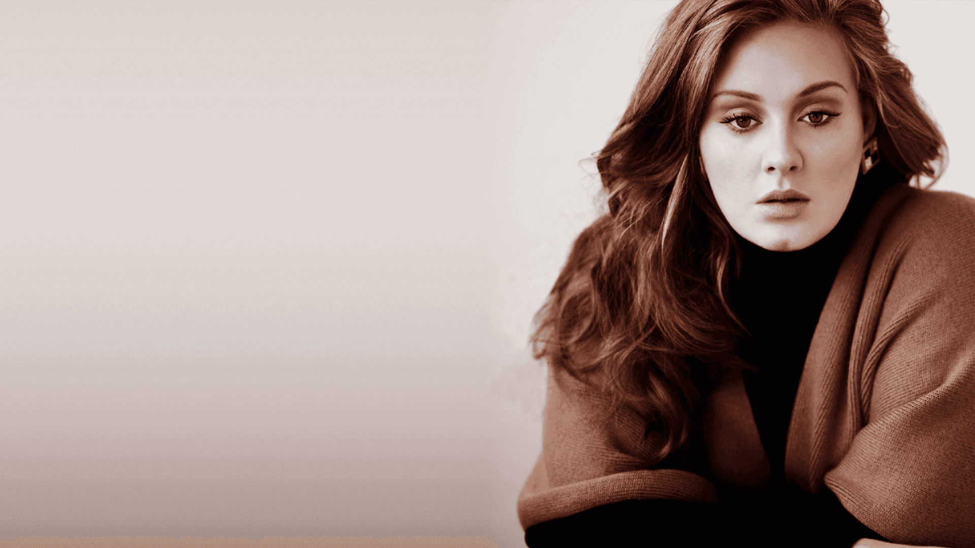 Adele - The British Actress and Singer Background — A woman with long wavy brown hair wears a brown cardigan over a black turtleneck against a soft neutral background.