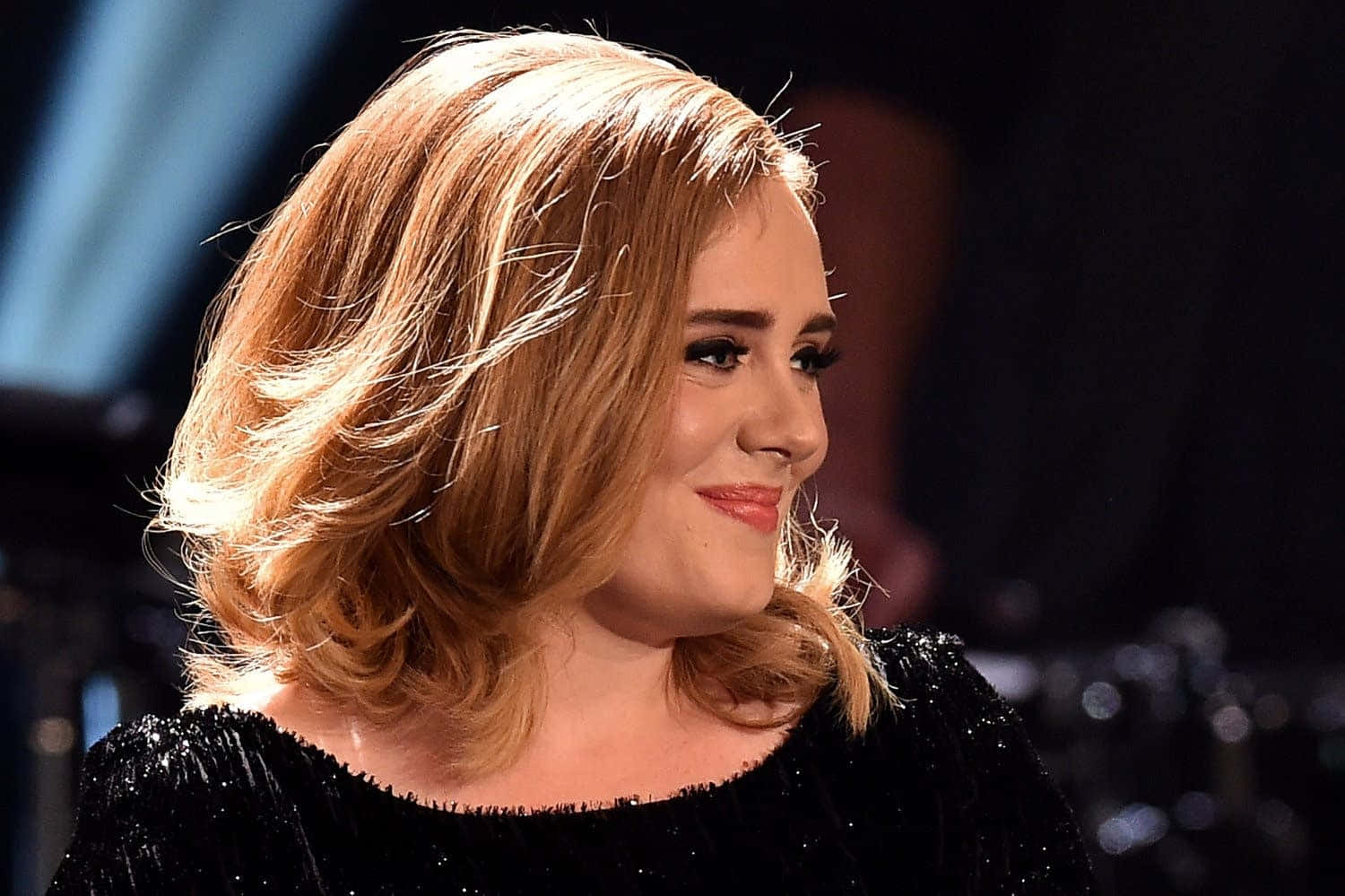 Singer Adele smiles to the camera.