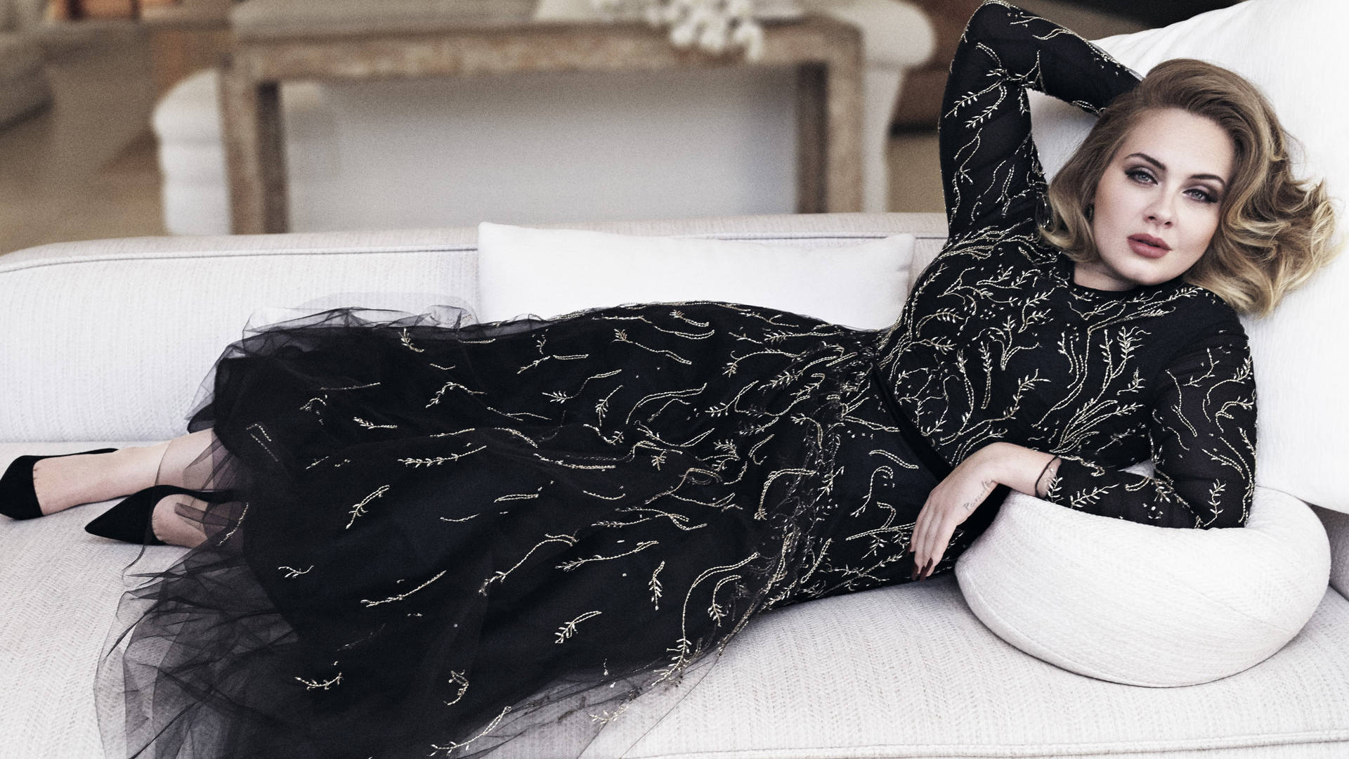 Adele Posing On A Sofa Background