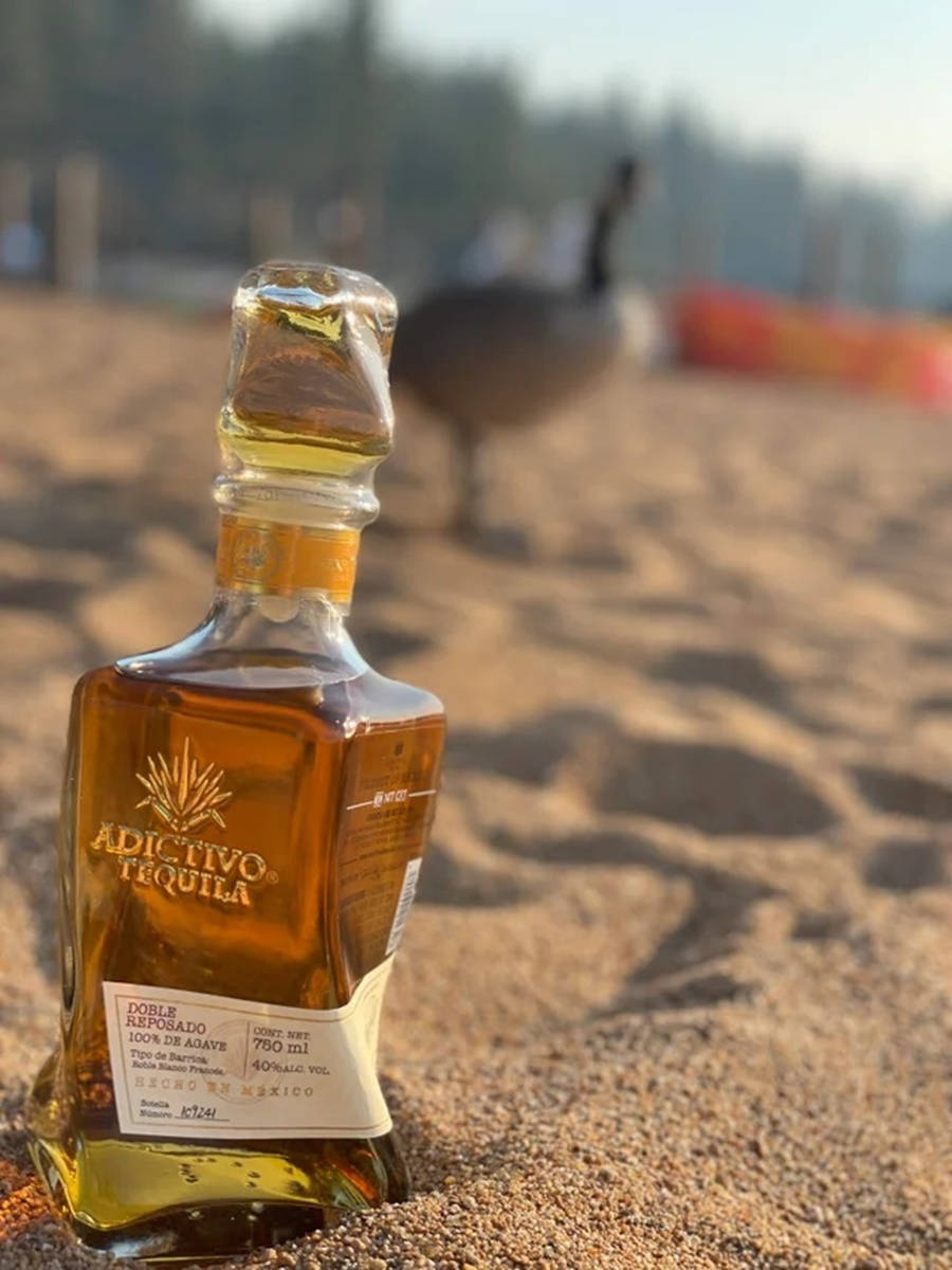 Adictivo Tequila On The Beach Background