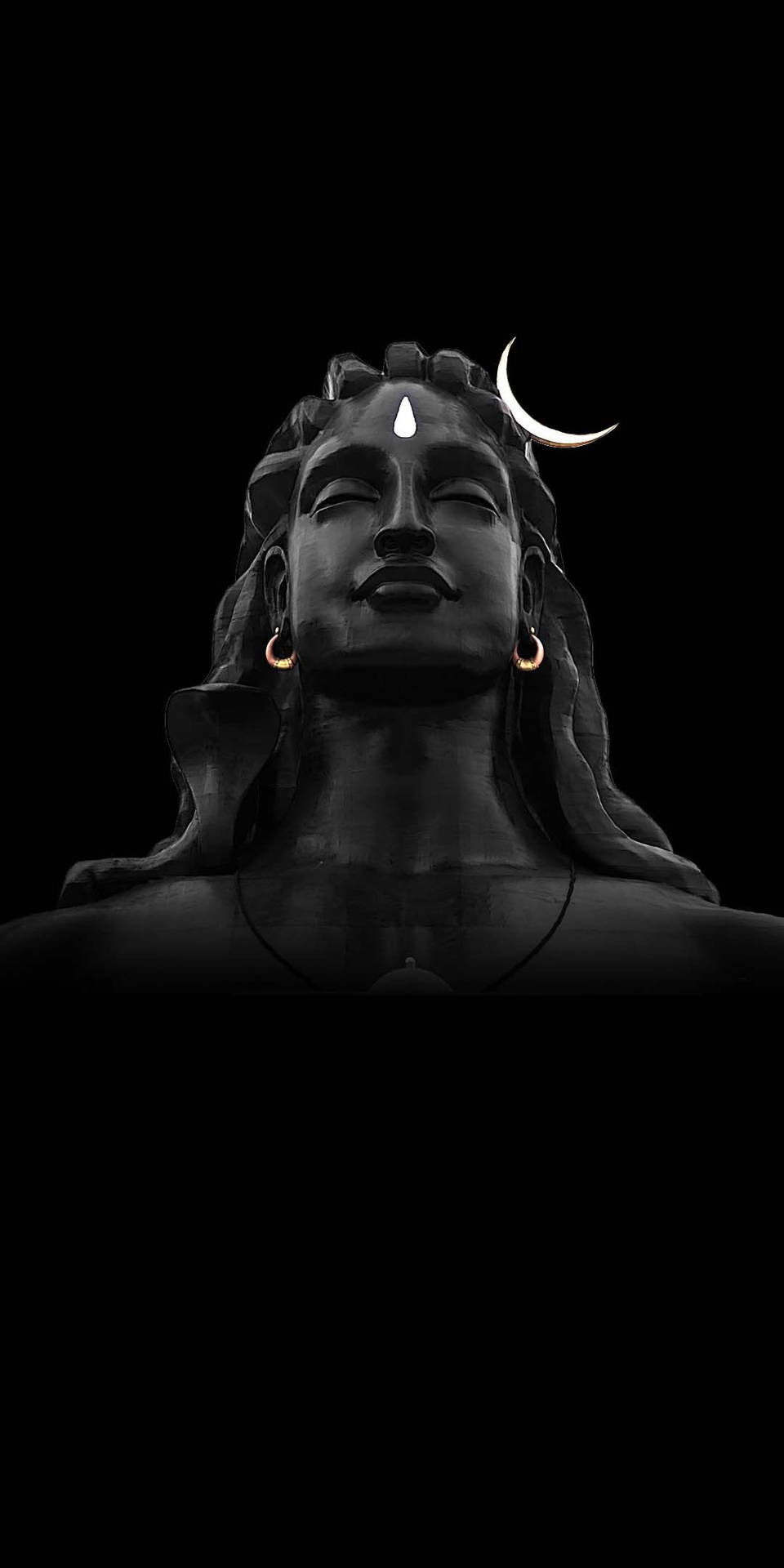 Majestic Adiyogi Shiva Statue Against a Dark Night Sky Wallpaper