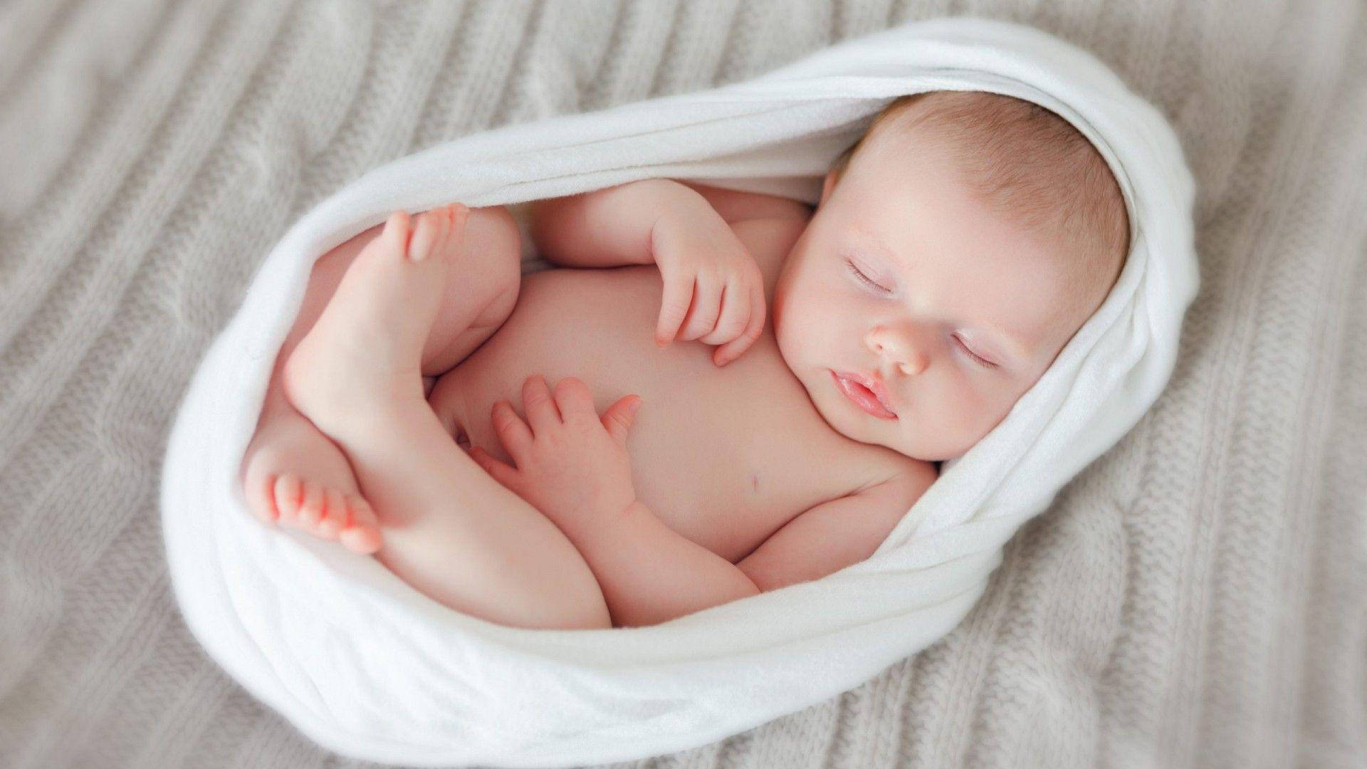 Adorable Newborn Baby Sleeping Peacefully Wallpaper