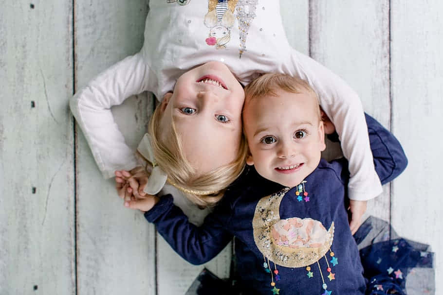 Aerial Photography Of Boy And His Cute Sister Wallpaper
