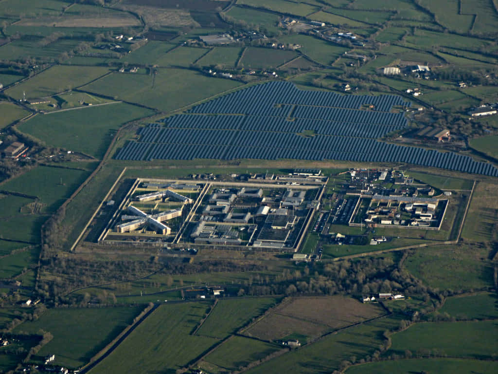 Aerial View Industrial Estate Next To Solar Farm Wallpaper