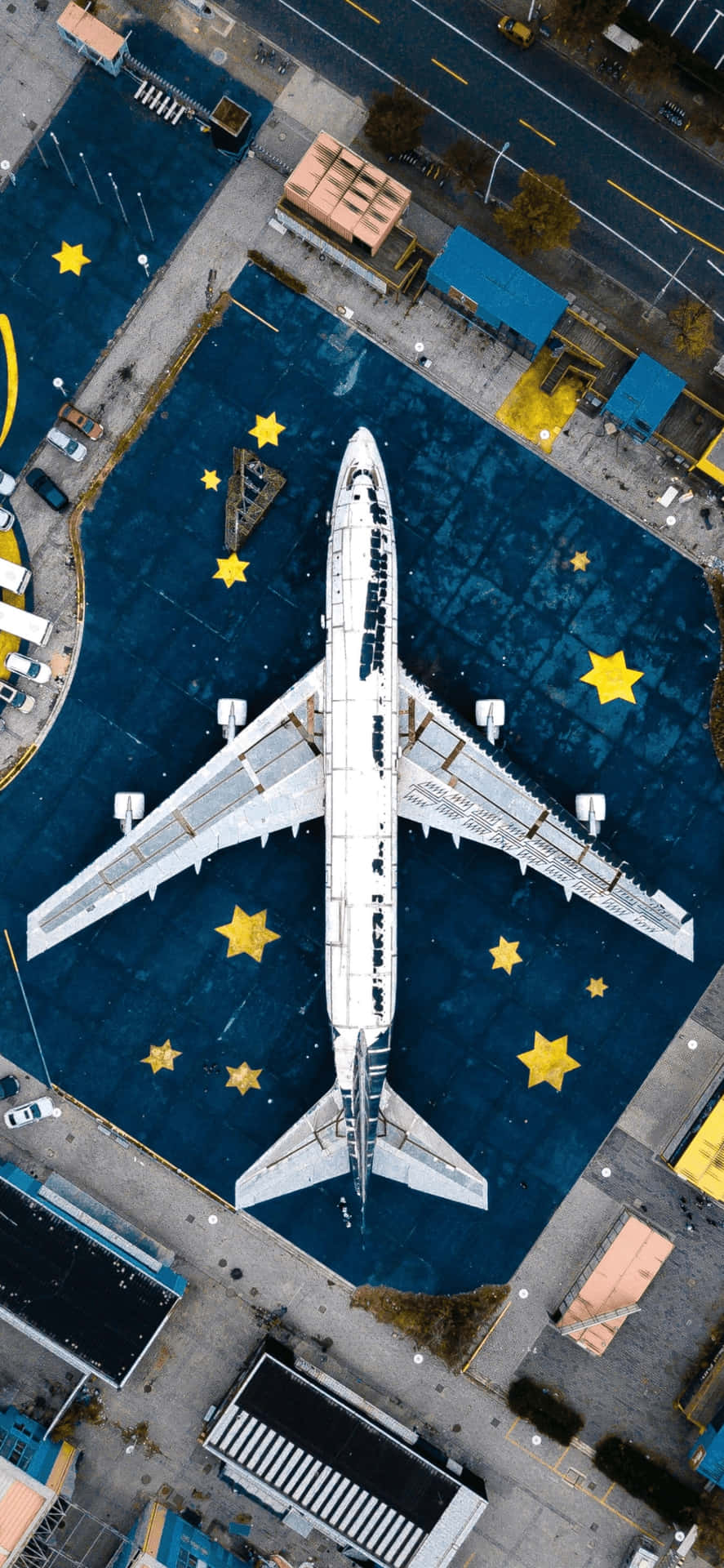 Aerial_ View_of_ Aircraft_at_ Gate_with_ Stars Wallpaper