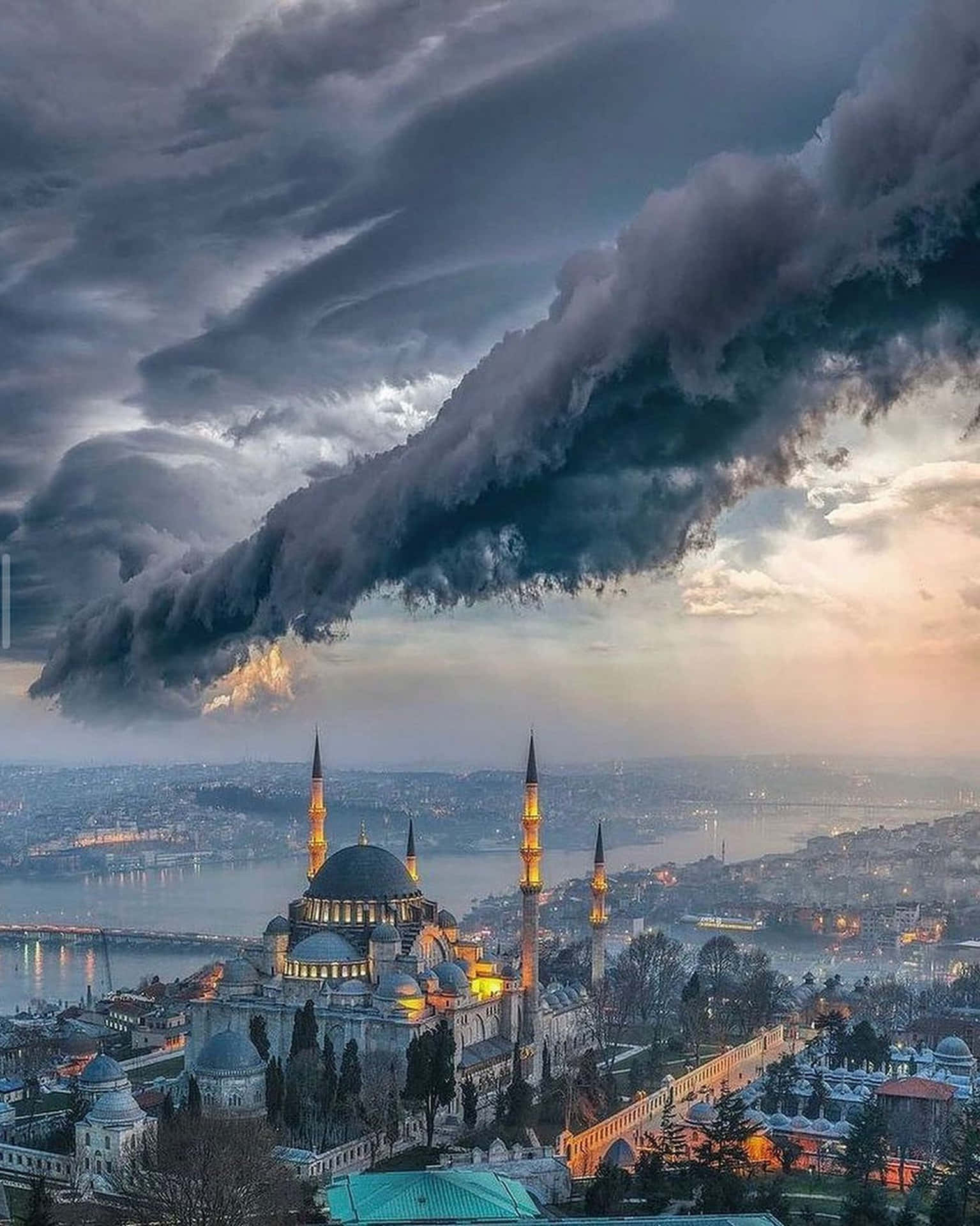 Captivating Aerial View of The Blue Mosque under stormy clouds Wallpaper