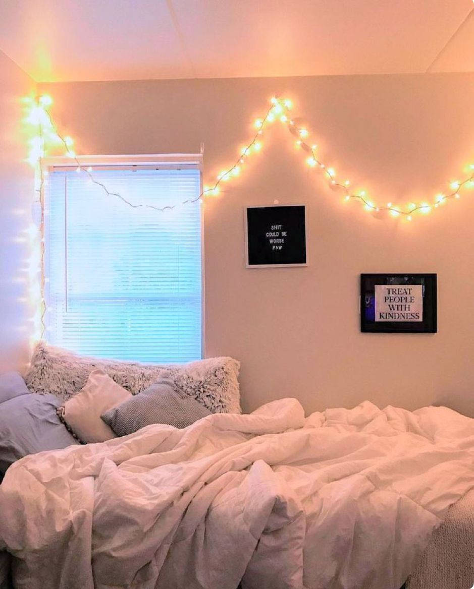 A Bed With Lights Hanging From The Ceiling Wallpaper