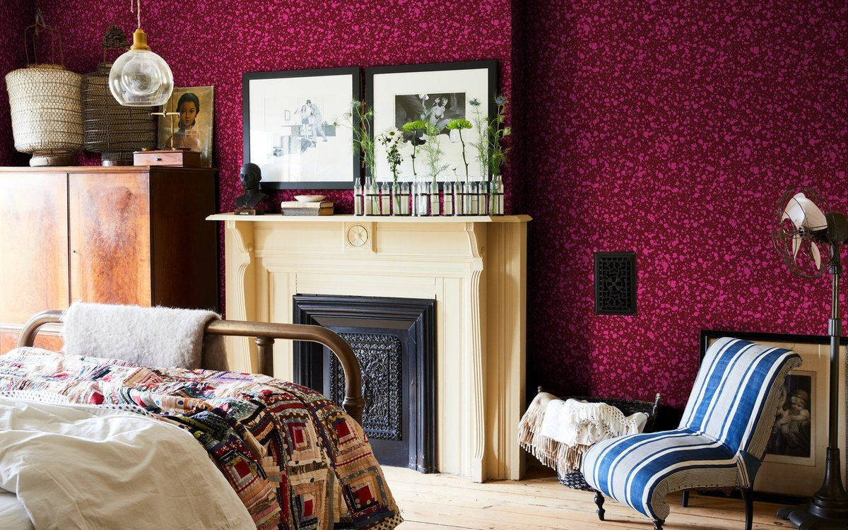 A Bedroom With Red Walls And A Fireplace Wallpaper