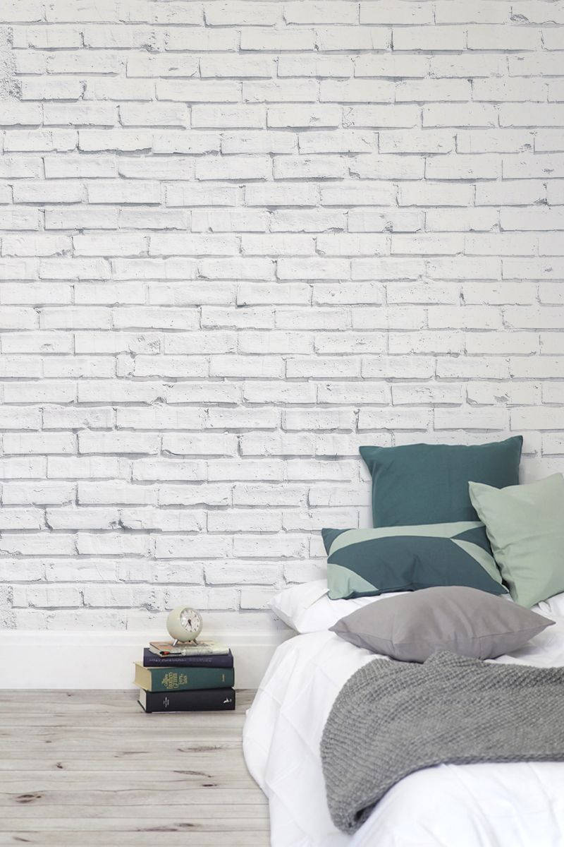 A White Brick Wall In A Bedroom Wallpaper