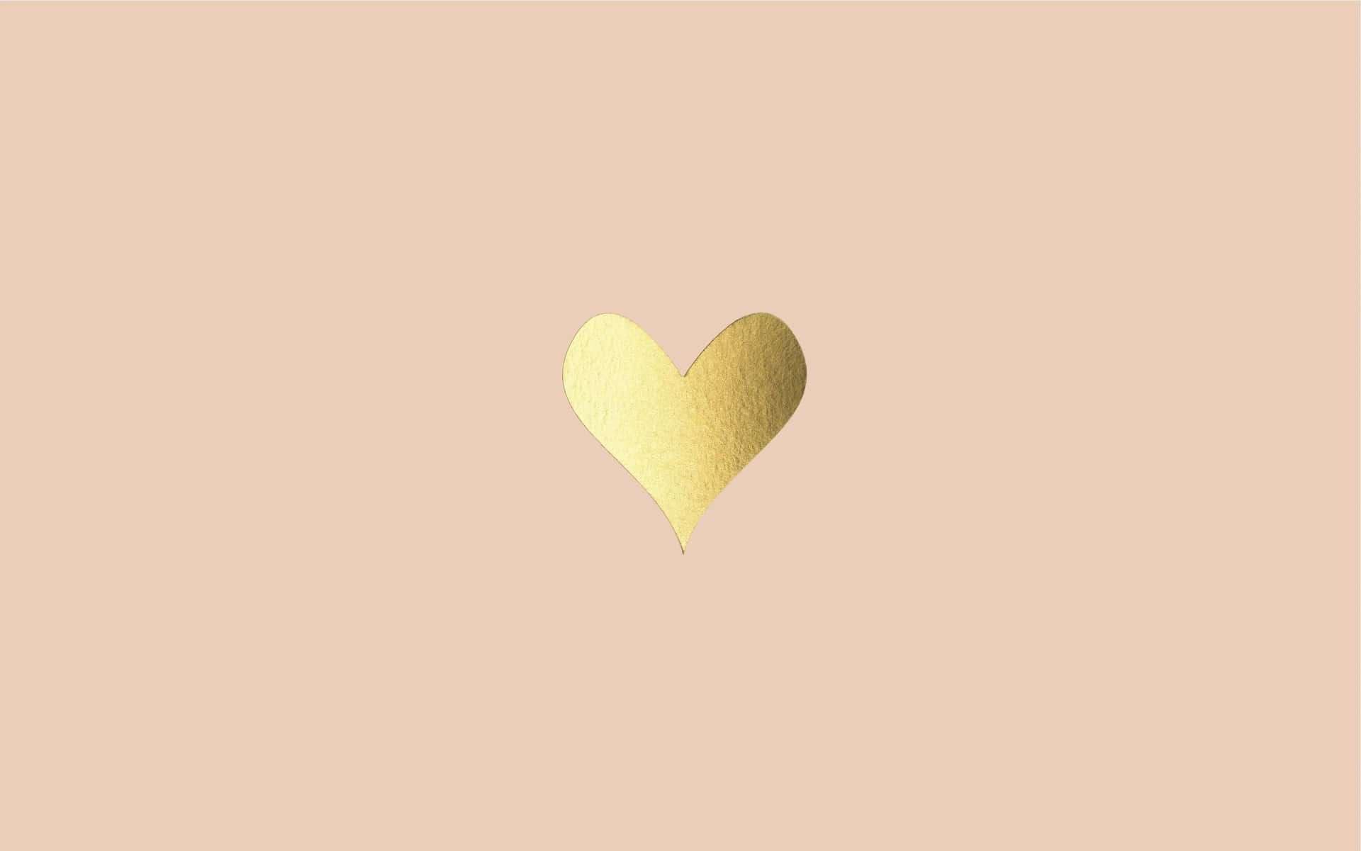 A Gold Heart On A Beige Background
