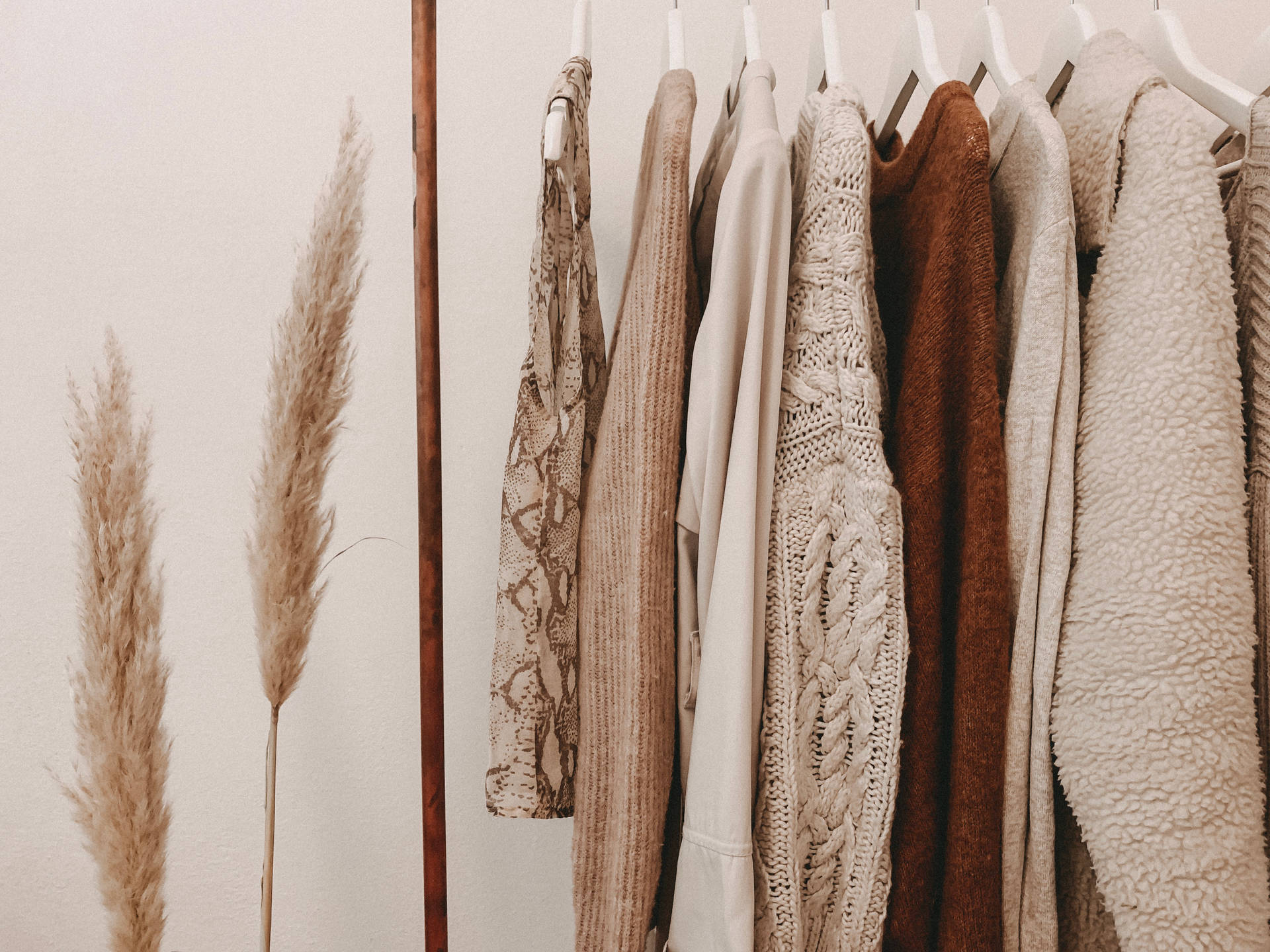 Aesthetic beige fashion rack wallpaper.