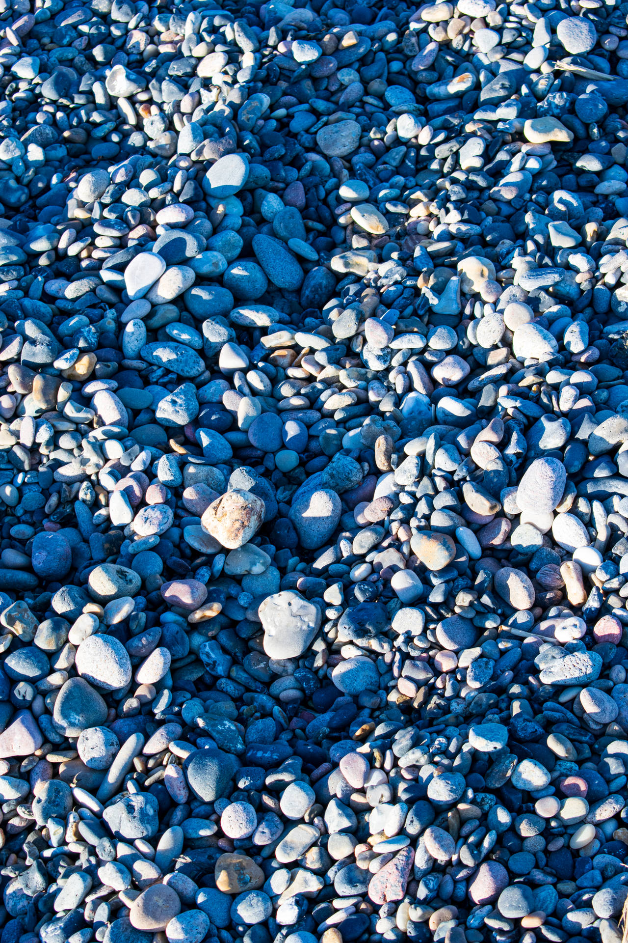 Aesthetic Blue Iphone Rock Pebbles Wallpaper