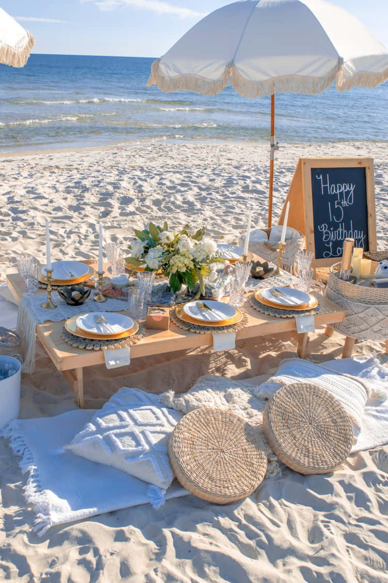 A Beach Party With White Tablecloths And White Umbrellas